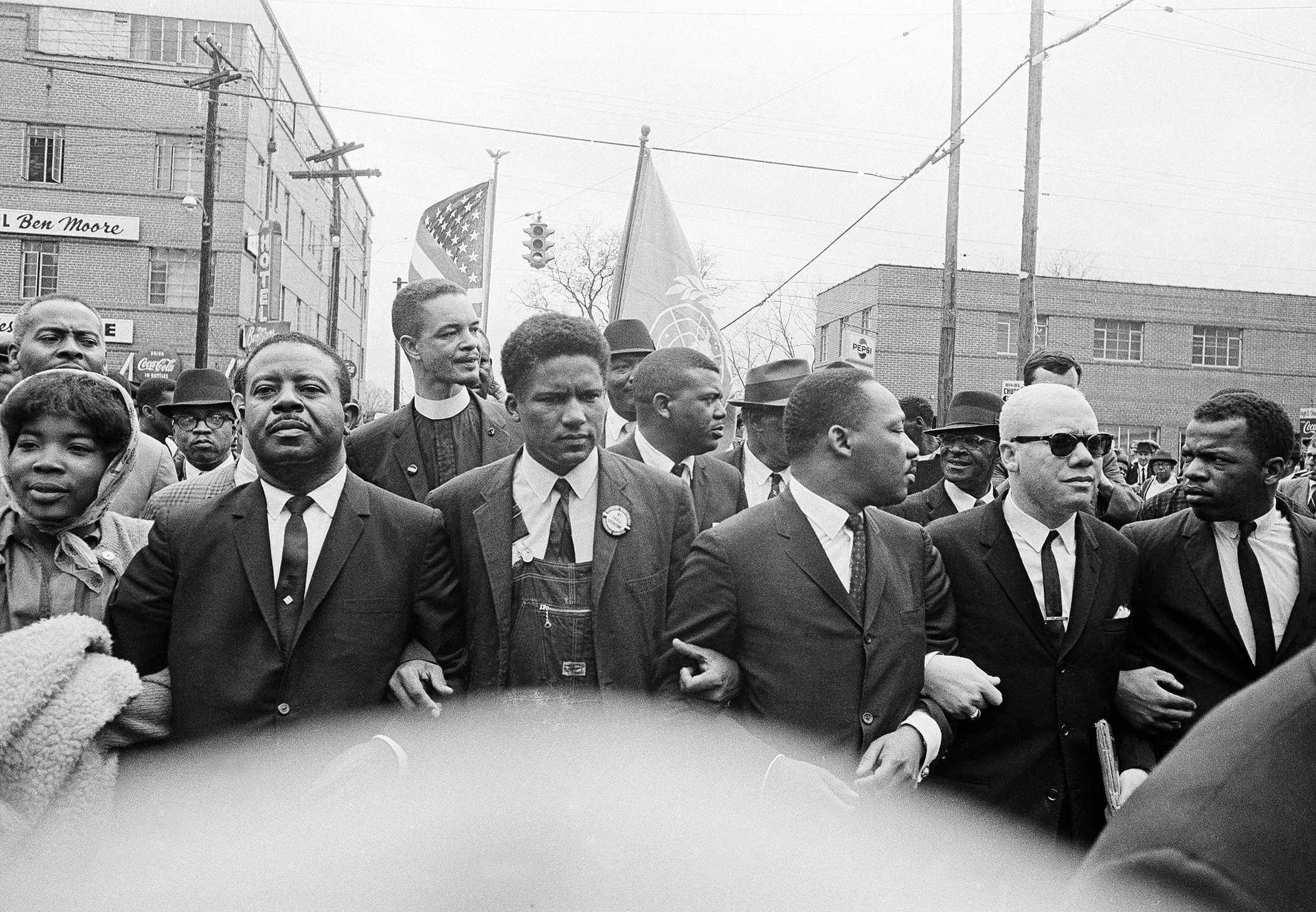 Dr. Martin Luther King Jr. locks arms as he leads a march of several thousand to the courthouse in Montgomery, Alabama, in March 1965. From left are: Rev. Ralph Abernathy, James Foreman, King, Jesse Douglas Sr., and John Lewis.