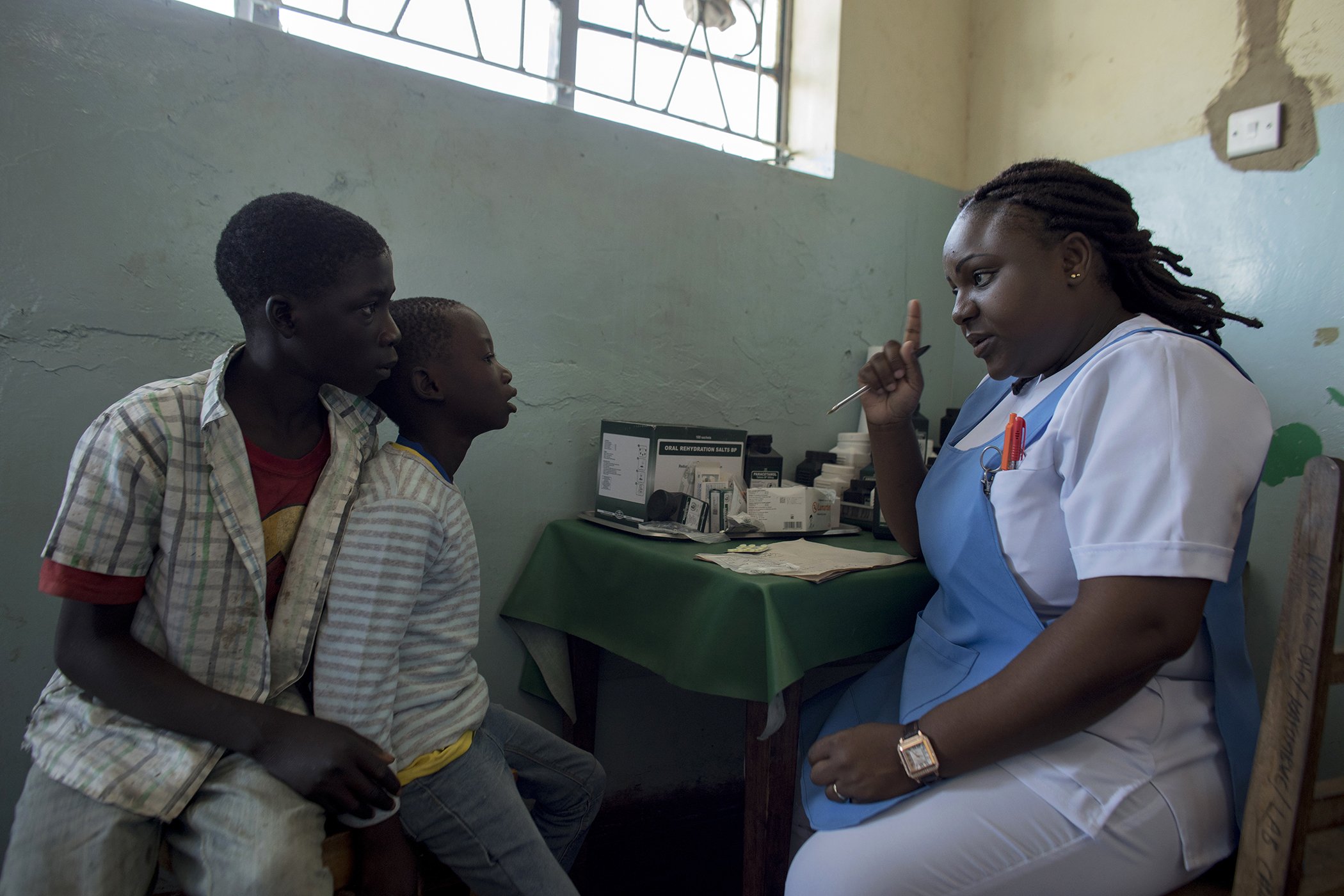 Mirriam Banda Chisamba speaks with patients at Kafumbwe Rural Health Center, Katete District, Eastern Province of Zambia.