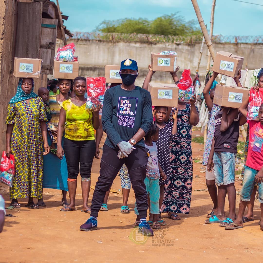 A Lagos Food Bank volunteer poses with beneficiaries of the foundation's food drive.