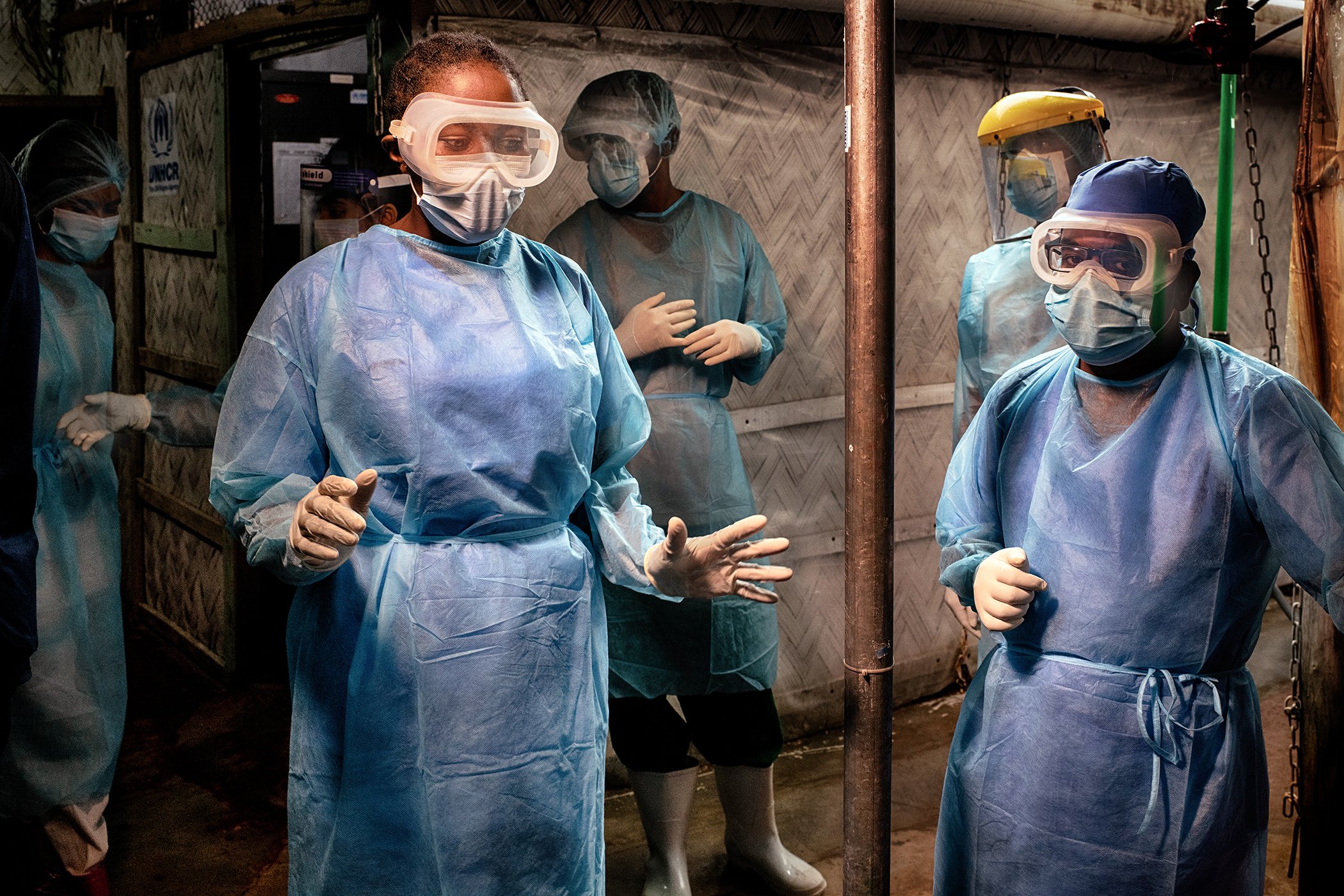 WHO Infection Prevention and Control Specialist Rebecca Rachel Apolot (left) is pictured in a Severe Acute Respiratory Infection Isolation and Treatment Center (SARI ITC) in a Rohingya camp.