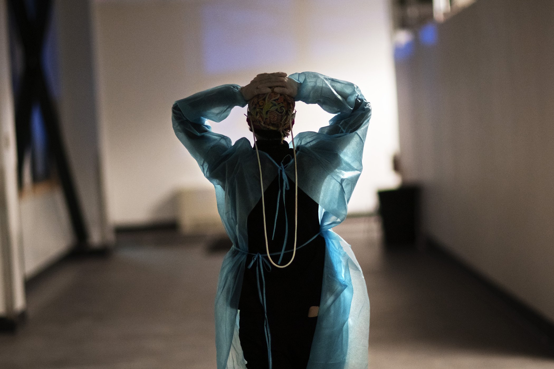 Registered traveling nurse Patricia Carrete, of El Paso, Texas, walks down the hallways during a night shift at a field hospital set up to handle a surge of COVID-19 patients, Feb. 10, 2021, in Cranston, RI.