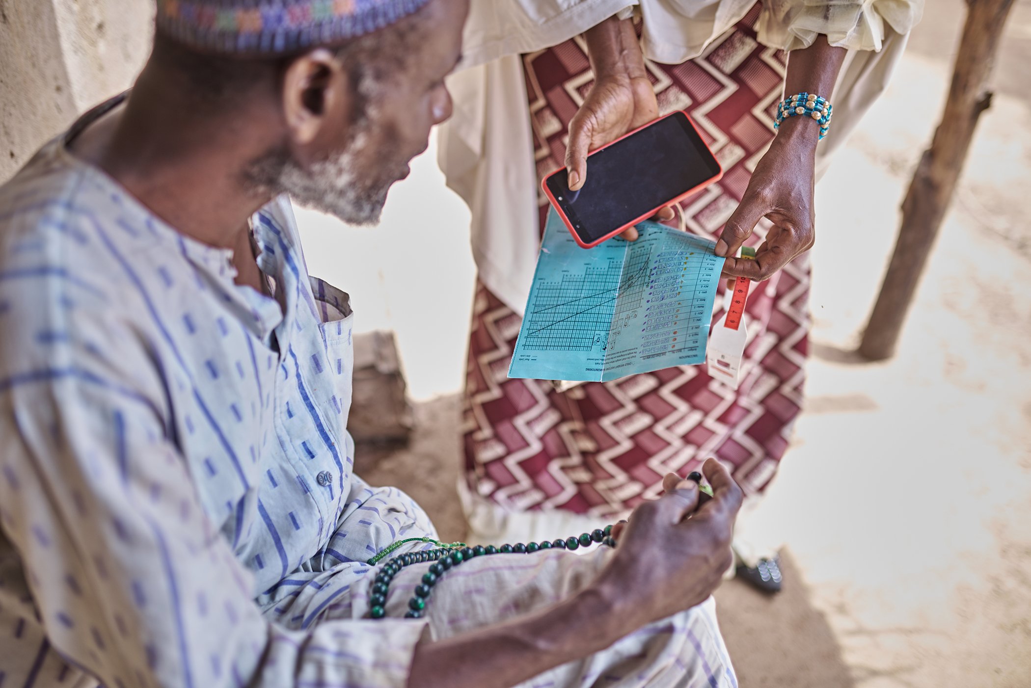 Furera Aliyu speaks to a father on the importance of immunizing his children in Nigeria's Bauchi State in October 2023.