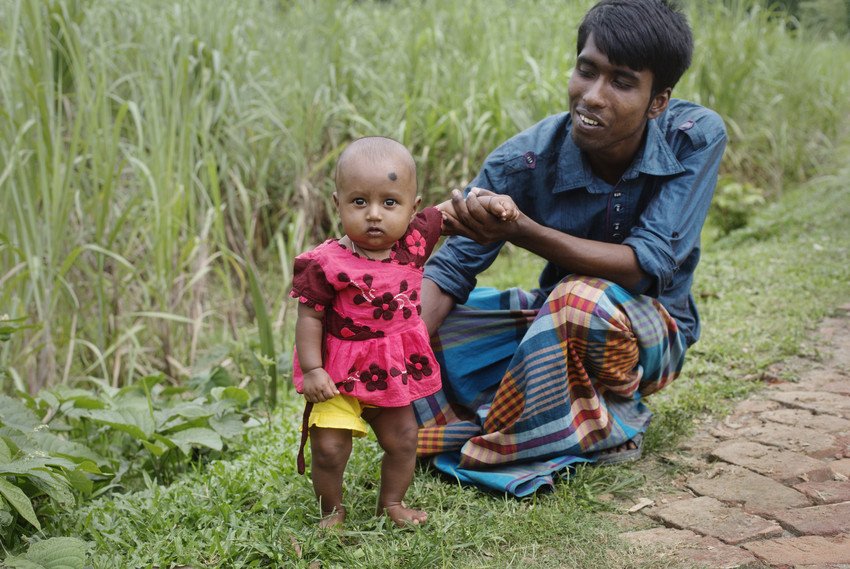 A man in Bangladesh with his baby daughter