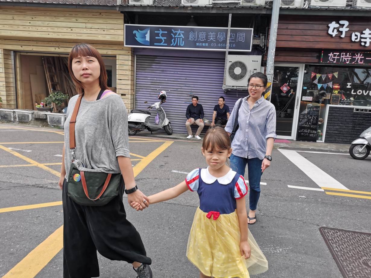 Lesbian couple Jovi Wu (R) and Mindy Chiu (L), with their daughter Allison Wu, walk across a street with their daughter in Zhongli District, Taoyuan City, Taiwan, May 5, 2019.