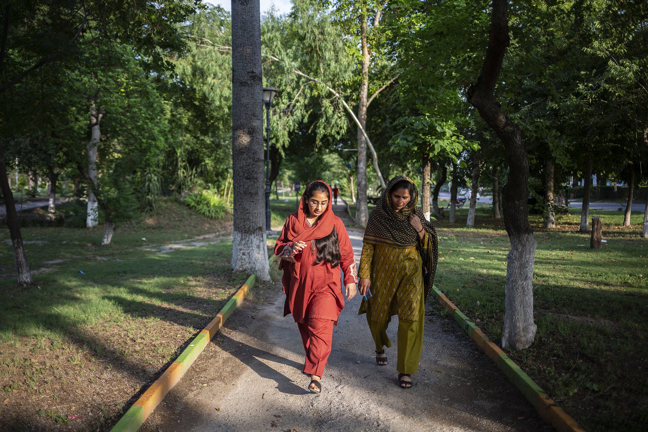 Zainab Waheed walks with her mother, Ghazala Tabasum, in Kachnar Park on June 27, 2023 in Islamabad, Pakistan.