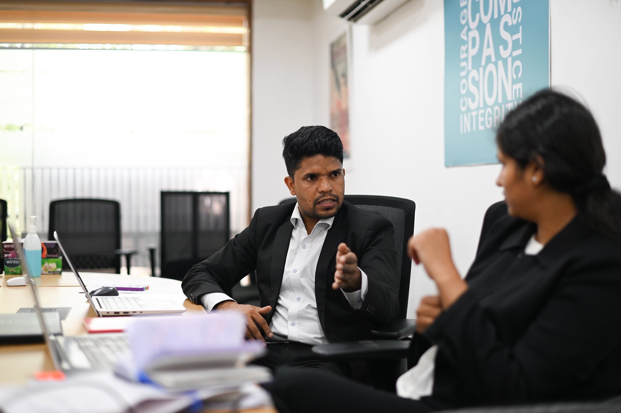 Amar Lal talks with a colleague at the Bachpan Bachao Andolan office in New Delhi on June 9, 2023.