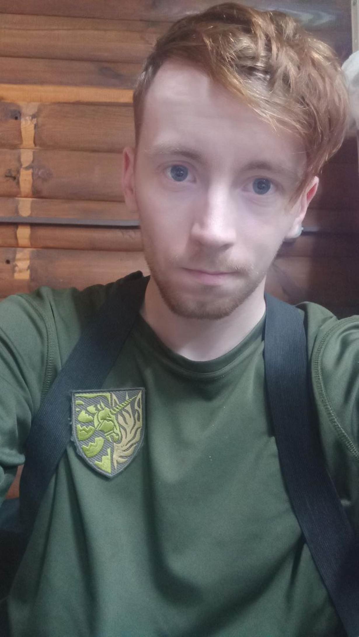 Vlad, a 25-year-old gay soldier in Kyiv, poses with the symbol of the first group of Ukrainian LGBTQ+ soldiers.