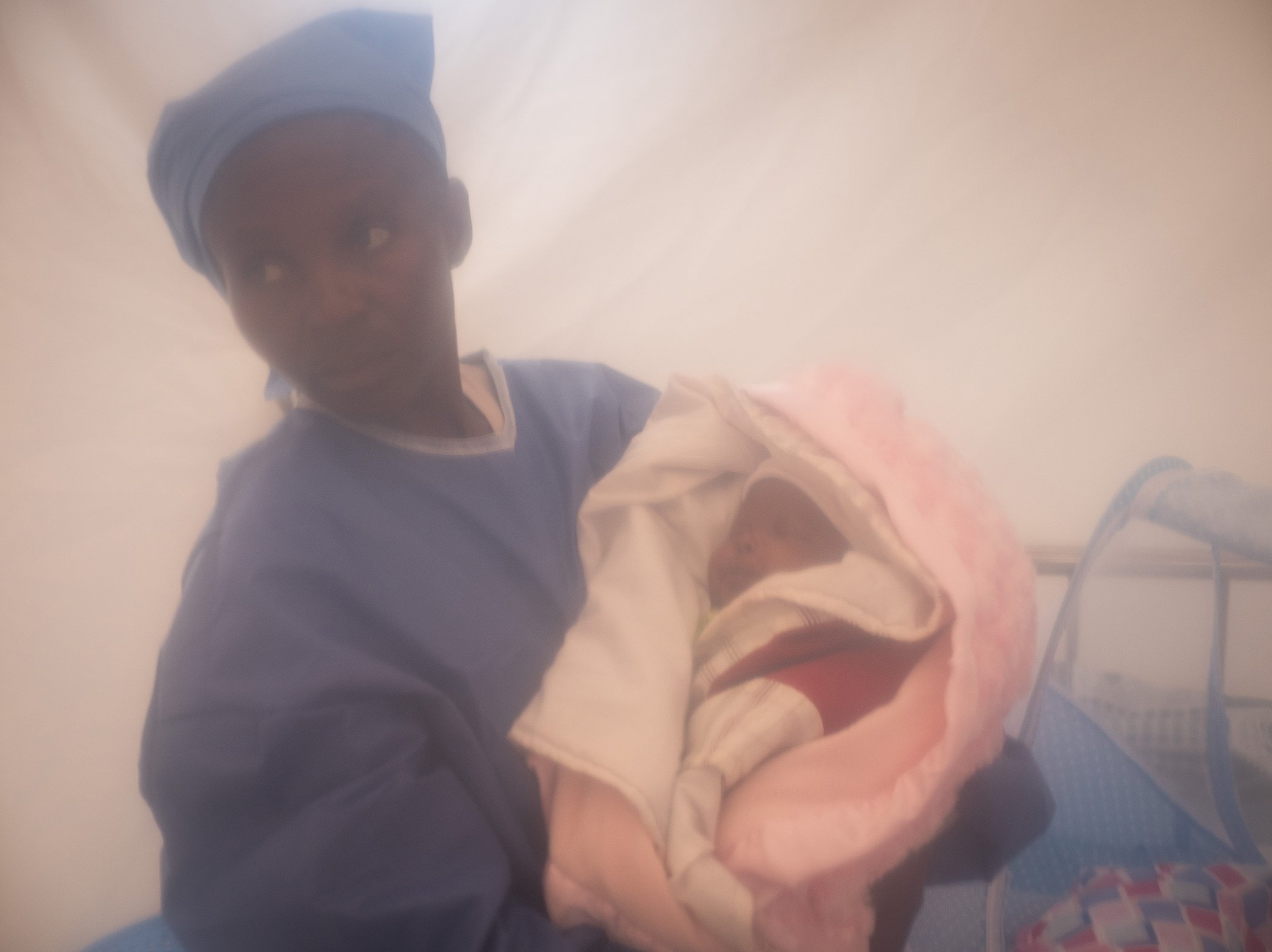 An Ebola survivor cares for a one week old child in an isolation tent at an Ebola treatment center in Beni, in the eastern DRC on Dec. 3, 2018.