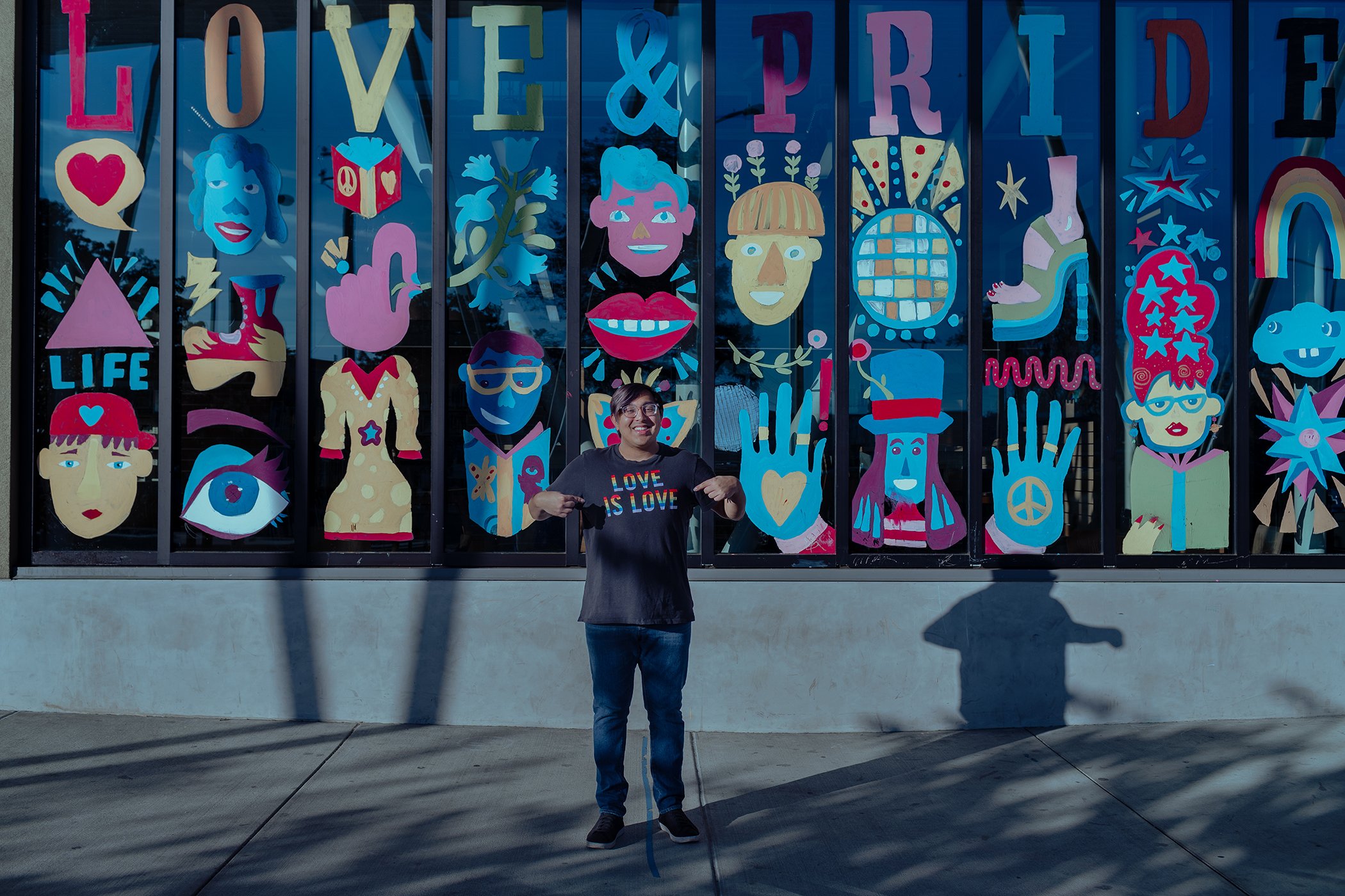Sameer Jha, founder of the Empathy Alliance, an organization dedicated to making schools safer and more inclusive for LGBTQ+ youth, poses for a portrait in front of the LGBTQ+ Pride Mural at the San Lorenzo Library in Fremont, Calif.