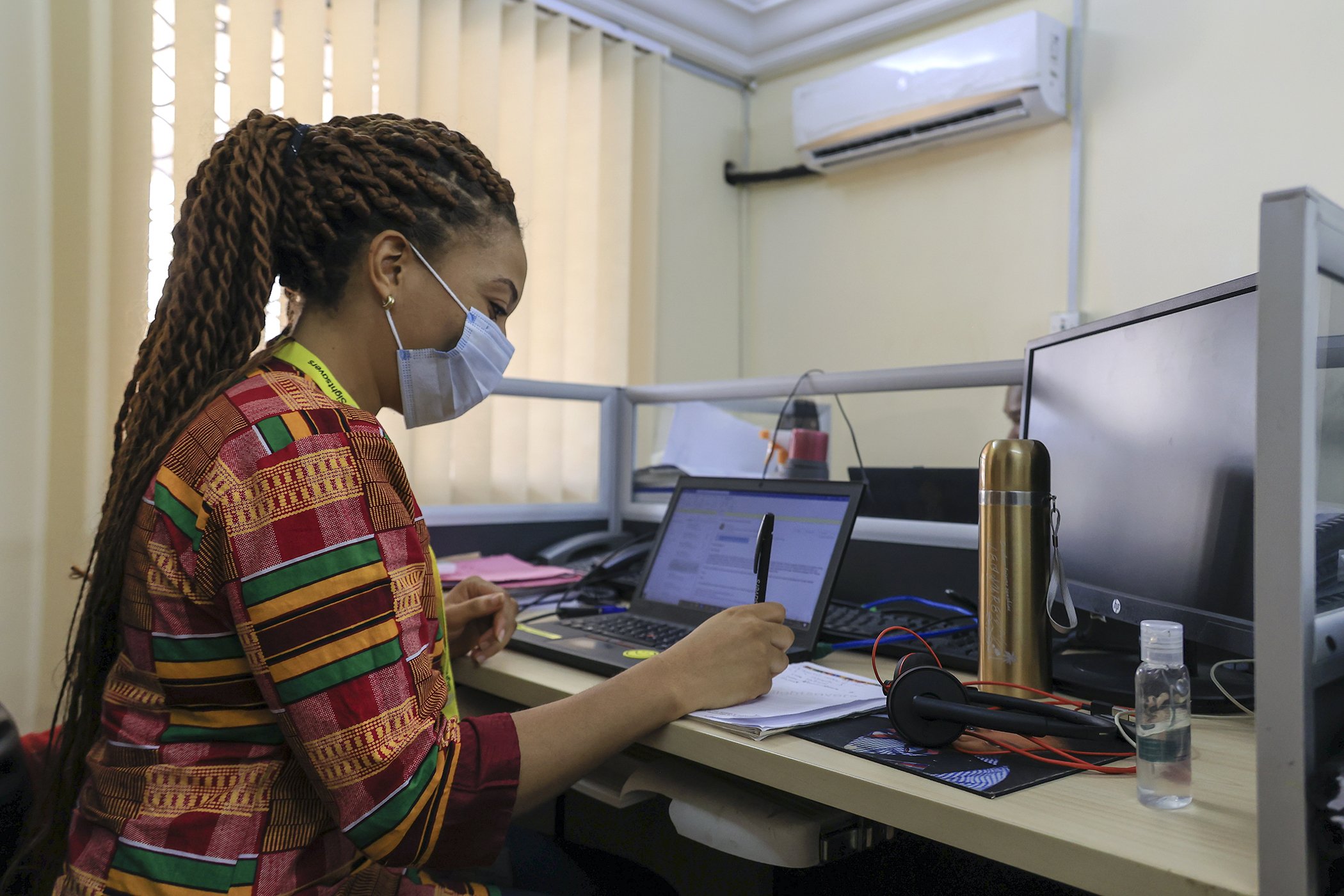 Kareen Atekem takes notes at the Sightsavers headquarters in Yaoundé, Cameroon. "Since the beginning of the Covid-19 pandemic, we have been doing a lot of teleworking... and the staff is reduced here at the NGO's headquarters," explained Atekem.