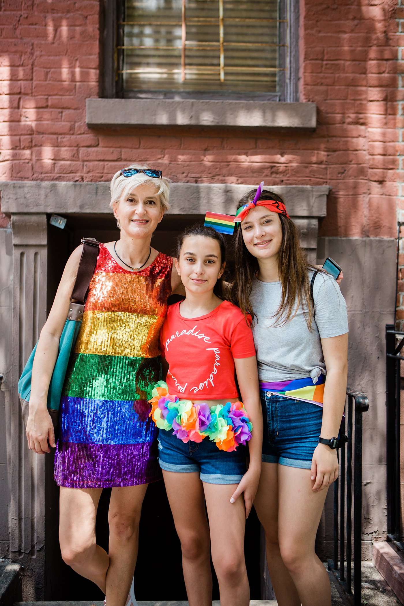 Lorna Vatta, 48, Zoe Meregalli, 12, Emma Meregalli, 15 from Milan, Italy at the 2018 NYC Pride March. The family is on their first day of vacation. They found out about the march on the morning of and got clothing to participate in the festivities.