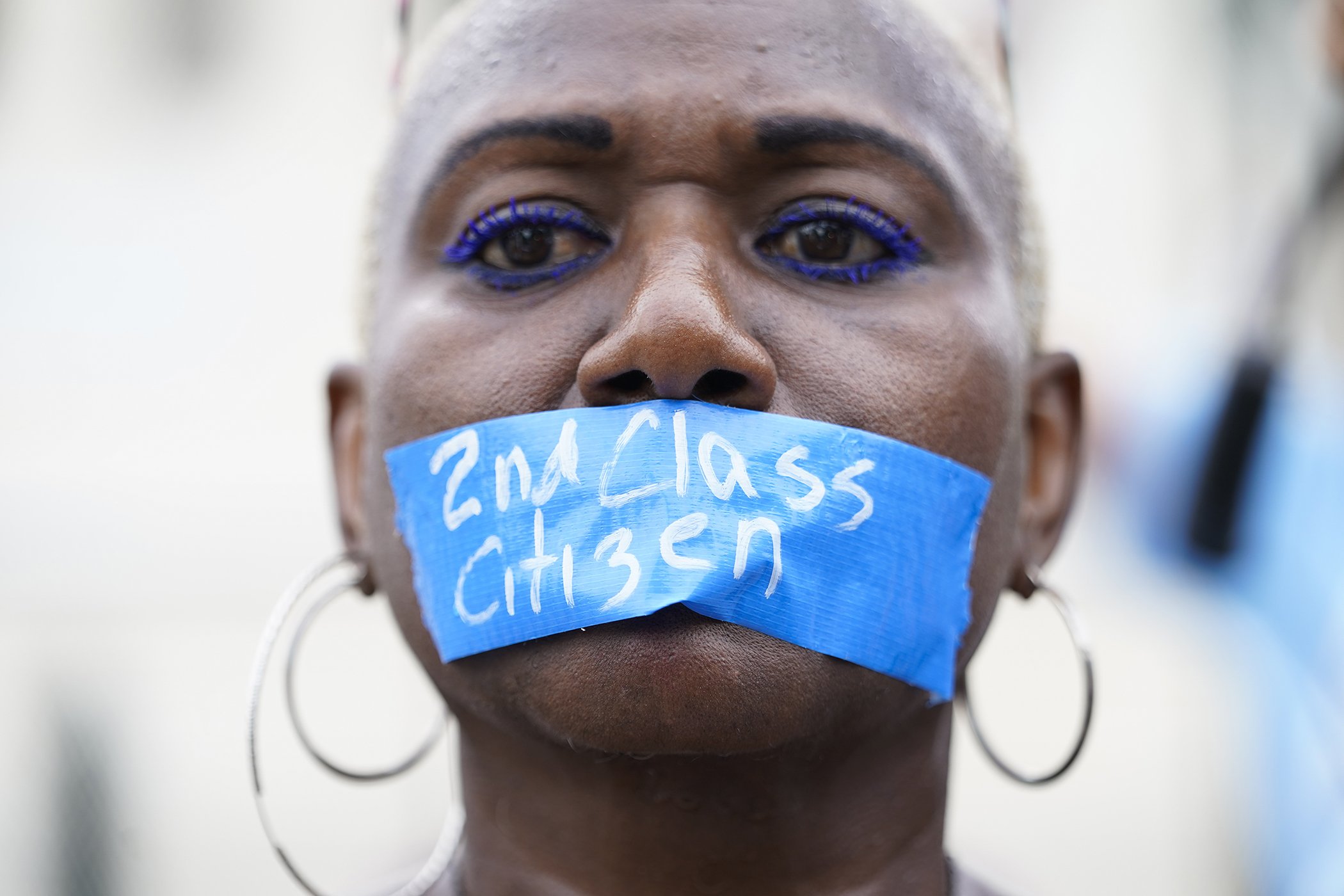 An abortion-rights activist wears tape reading "2nd Class Citizen" on their mouth as they protest outside the Supreme Court in Washington, June 24, 2022.