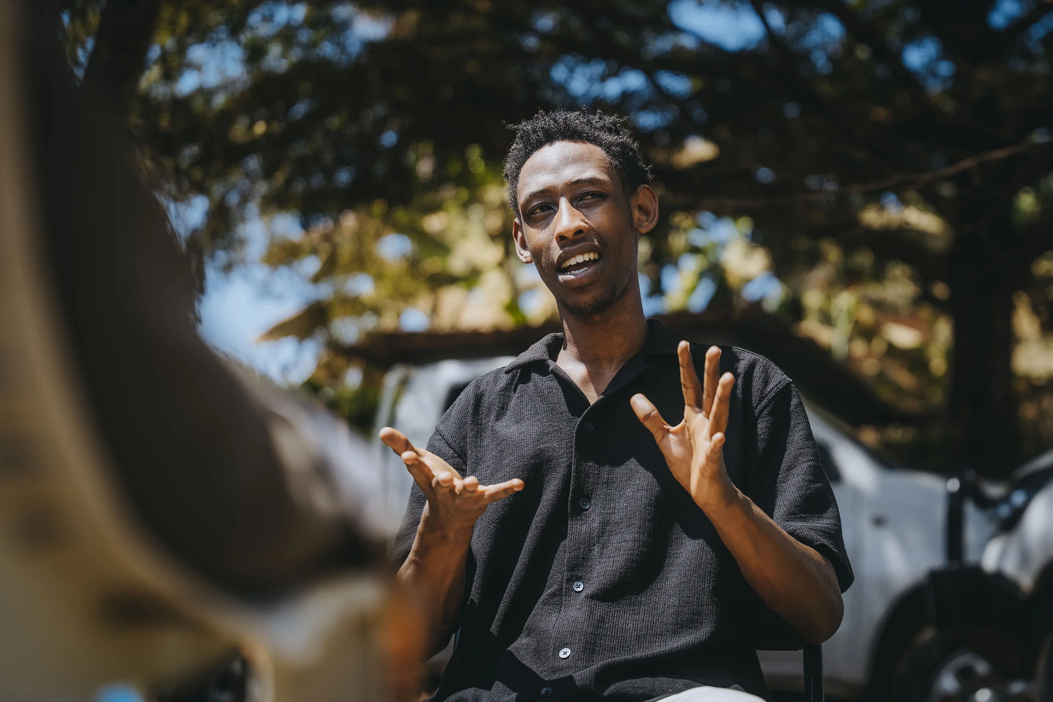 Fredy Mugisha speaks with Global Citizen in Rwanda in June 2026. Mugisha works as a youth champion with HDI, helping other young people understand and access reproductive health information.