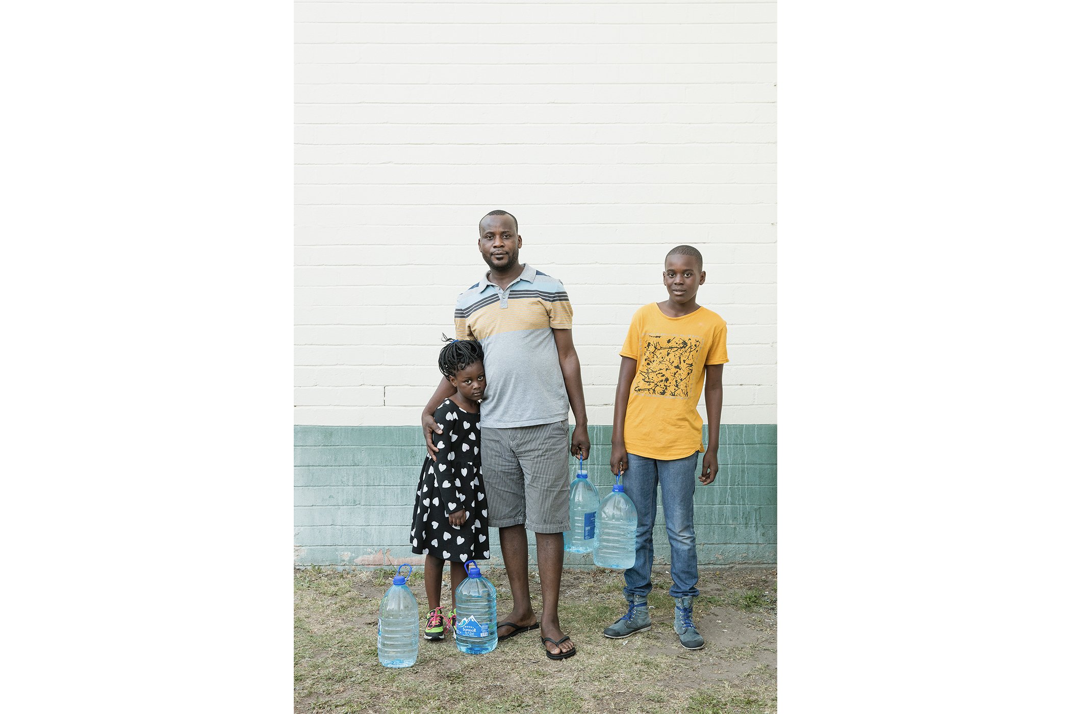 Miguel, Jancinth and Jayden collect water from the Newlands Spring, Cape Town.