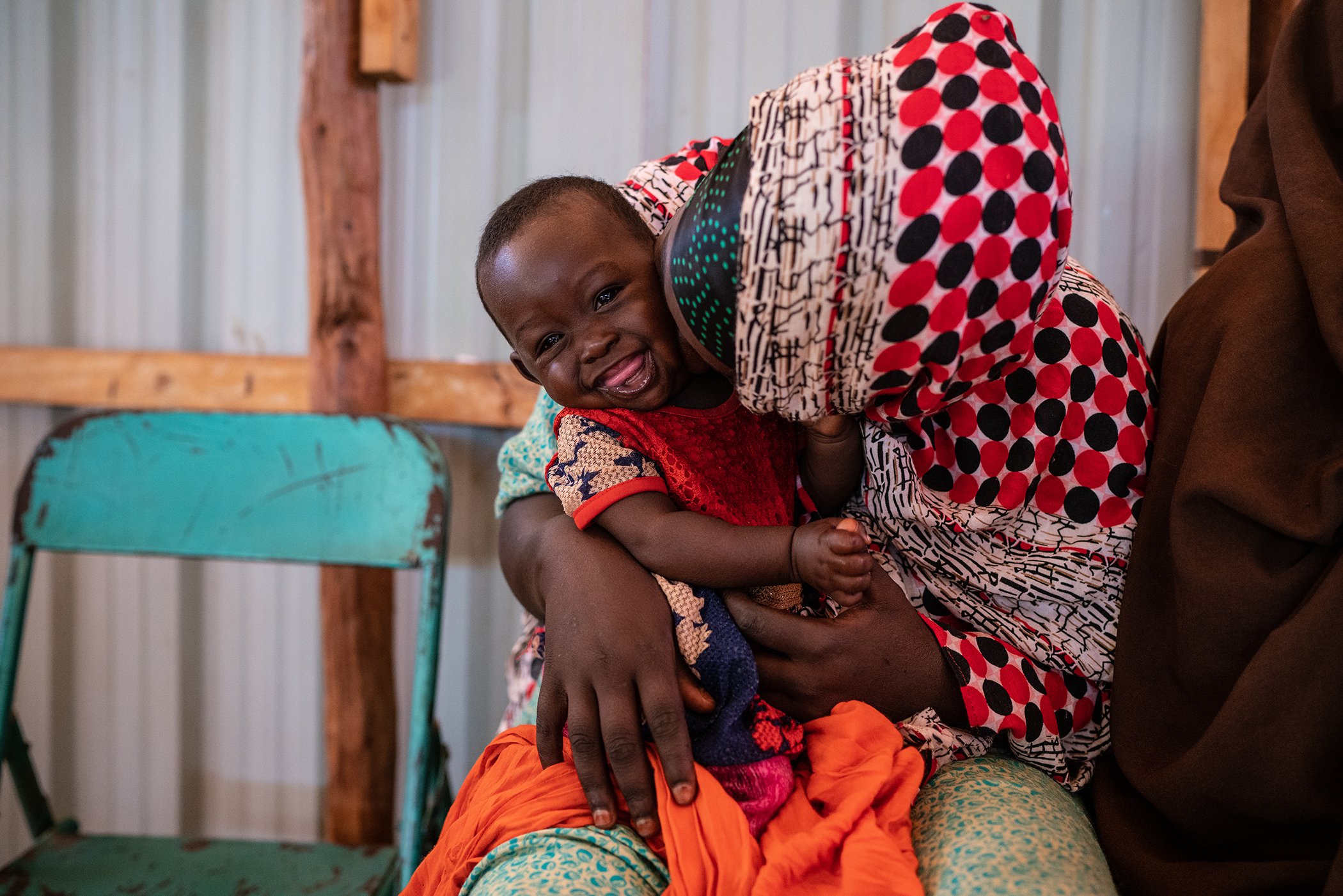 A mother kisses her child at a UNICEF-supported health clinic Kabasa IDP Camp, Dollow, Somalia, Monday, Dec. 17, 2018.