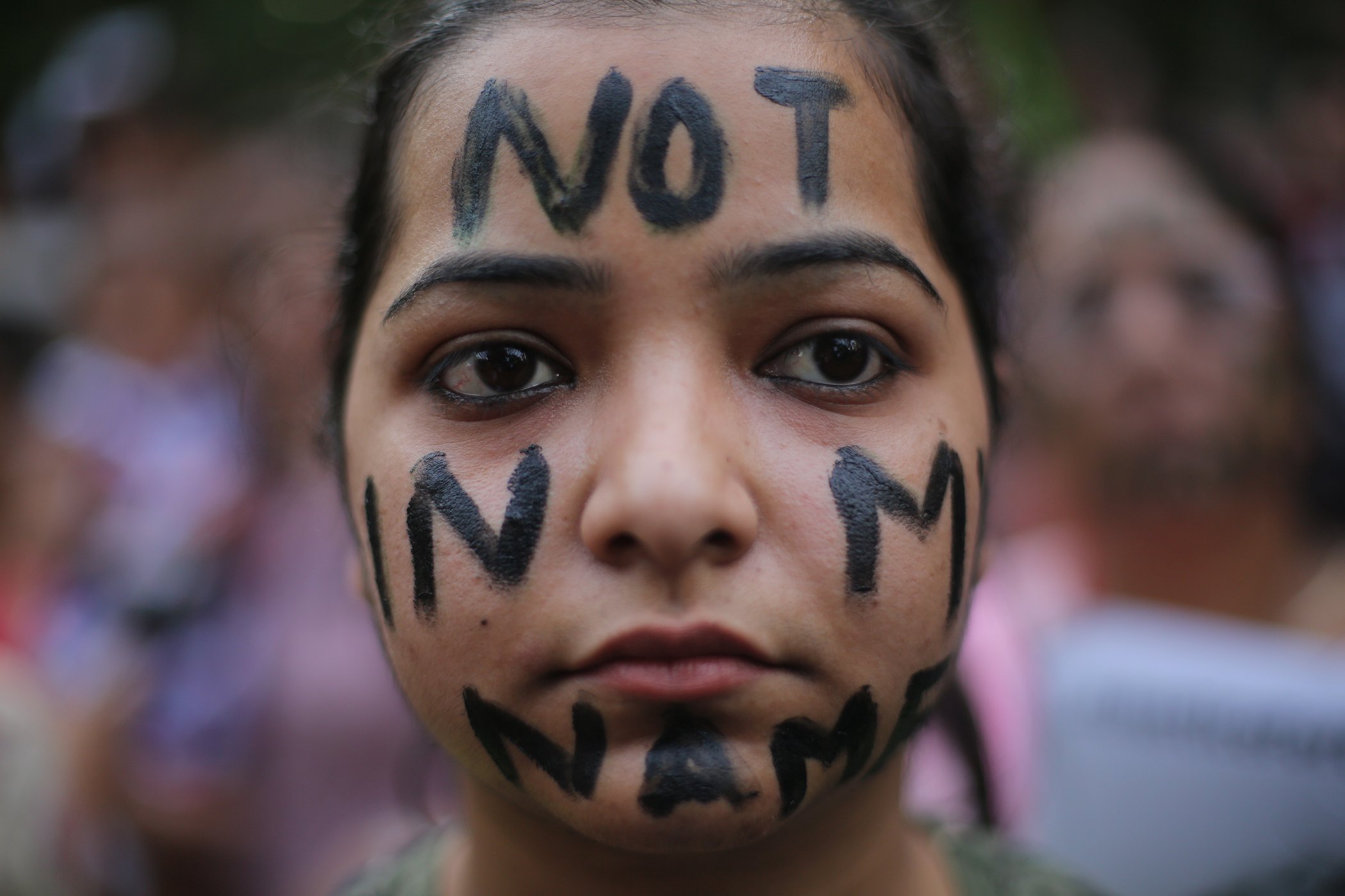 A participant has the words "not in my name" painted on face during a protest against two recently reported rape cases as protestors gather near the Parliament in New Delhi, India, April 15, 2018.