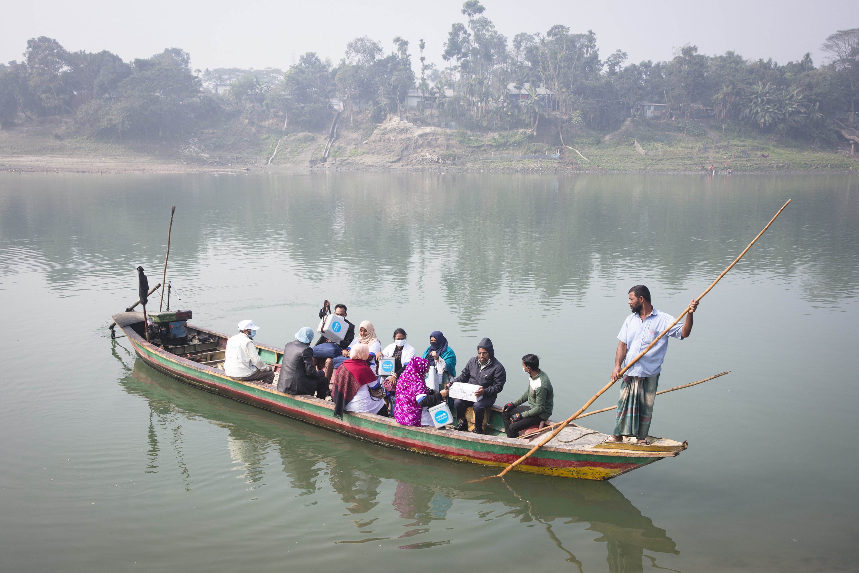 Health workers travel with vaccines to get to a remote outreach center at Trishal, Mymensingh, Bangladesh on Jan. 20, 2021.