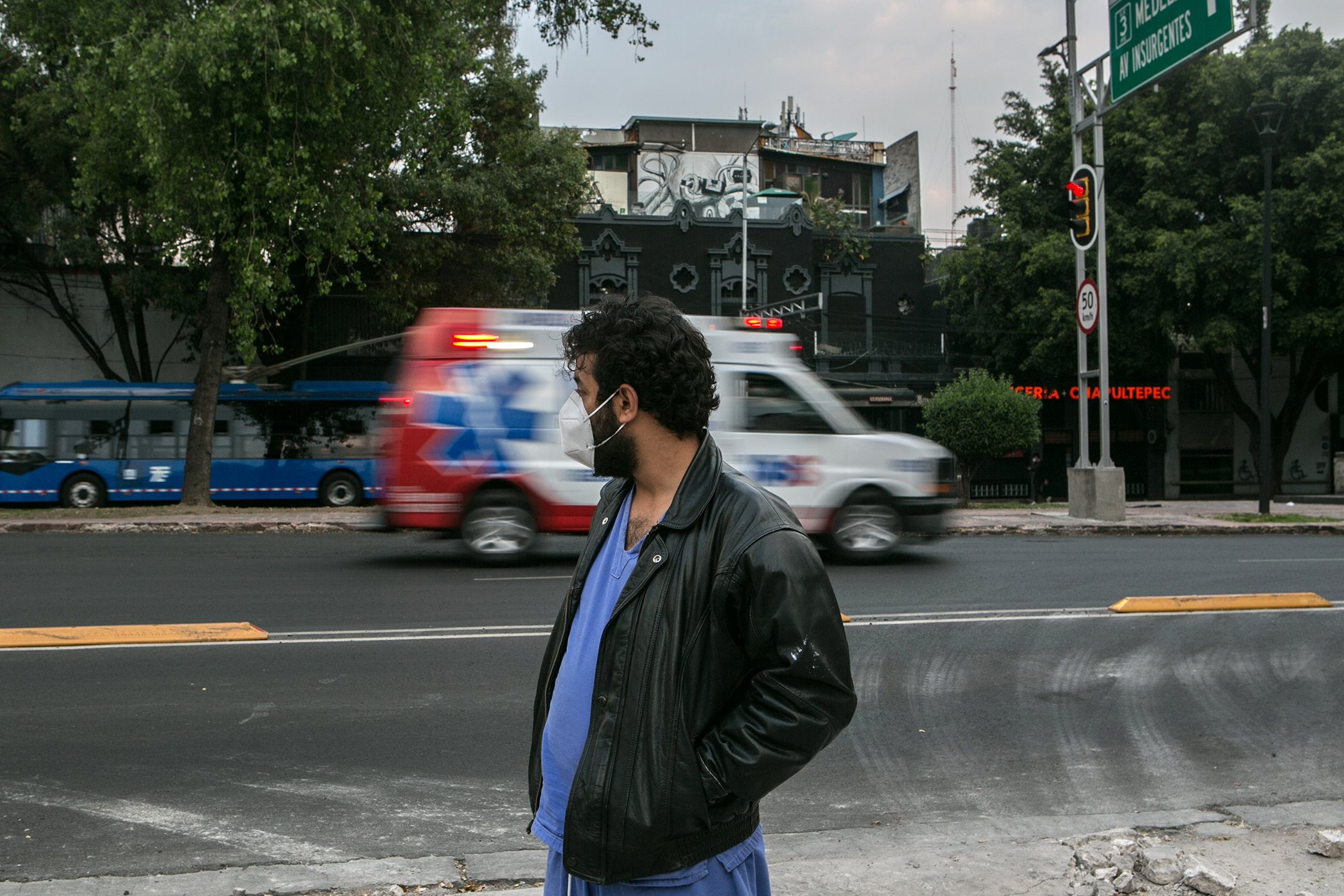 Dr. Giorgio Franyuti, biosecurity expert and founder of the NGO Medical Impact, watches an ambulance speed by on a busy road in Mexico City on Dec. 20, 2020.