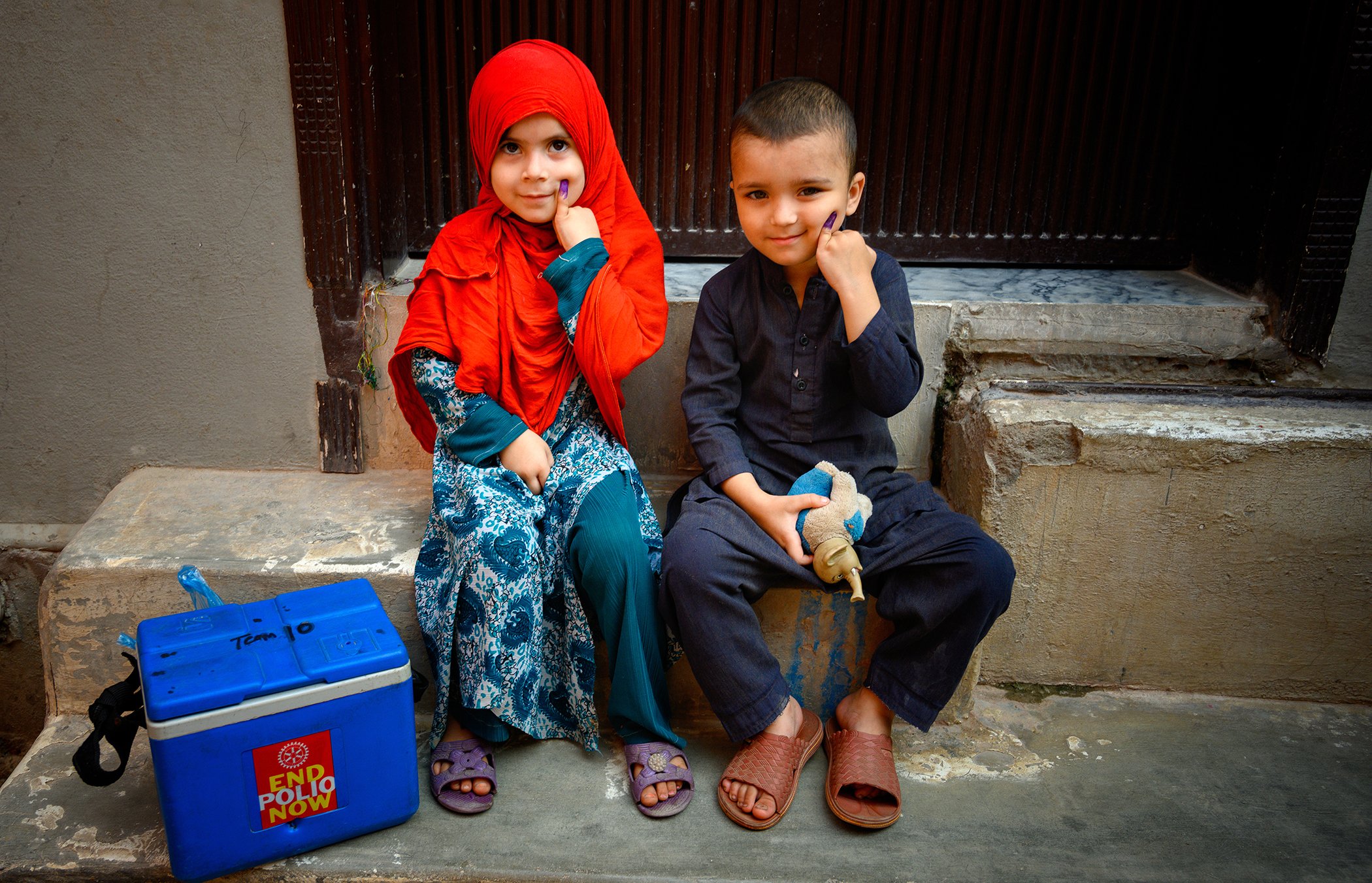Siblings show their marked fingers after receiving the polio vaccine in Rawalpindi, Pakistan on Sept. 22, 2020. After a six-month pause due to COVID-19, the country’s first polio vaccination campaign reached over 39 million children under 5.