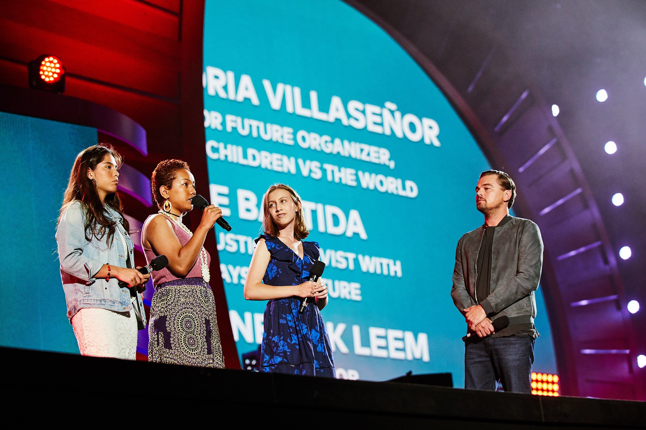 Climate activists Xiye Bastida, Selina Neirok Leem, Alexandria Villaseñor speak on stage as Leonardo DiCaprio listens during the Global Citizen Festival on Sept. 28, 2019, in New York City.