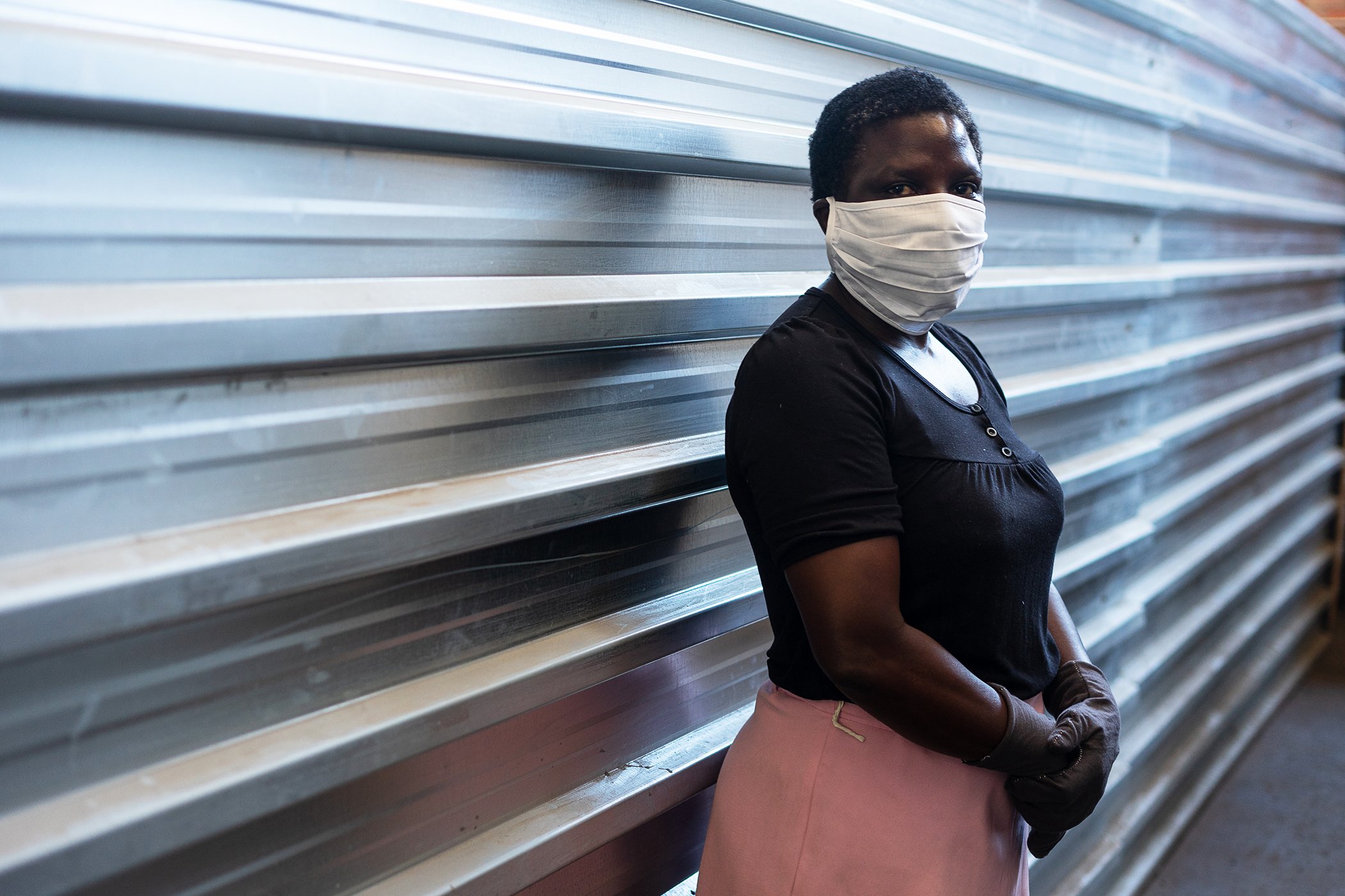 A woman working in a face mask manufacturing shop at a downtown factory poses for a factory. Bulawayo, April 24, 2020.