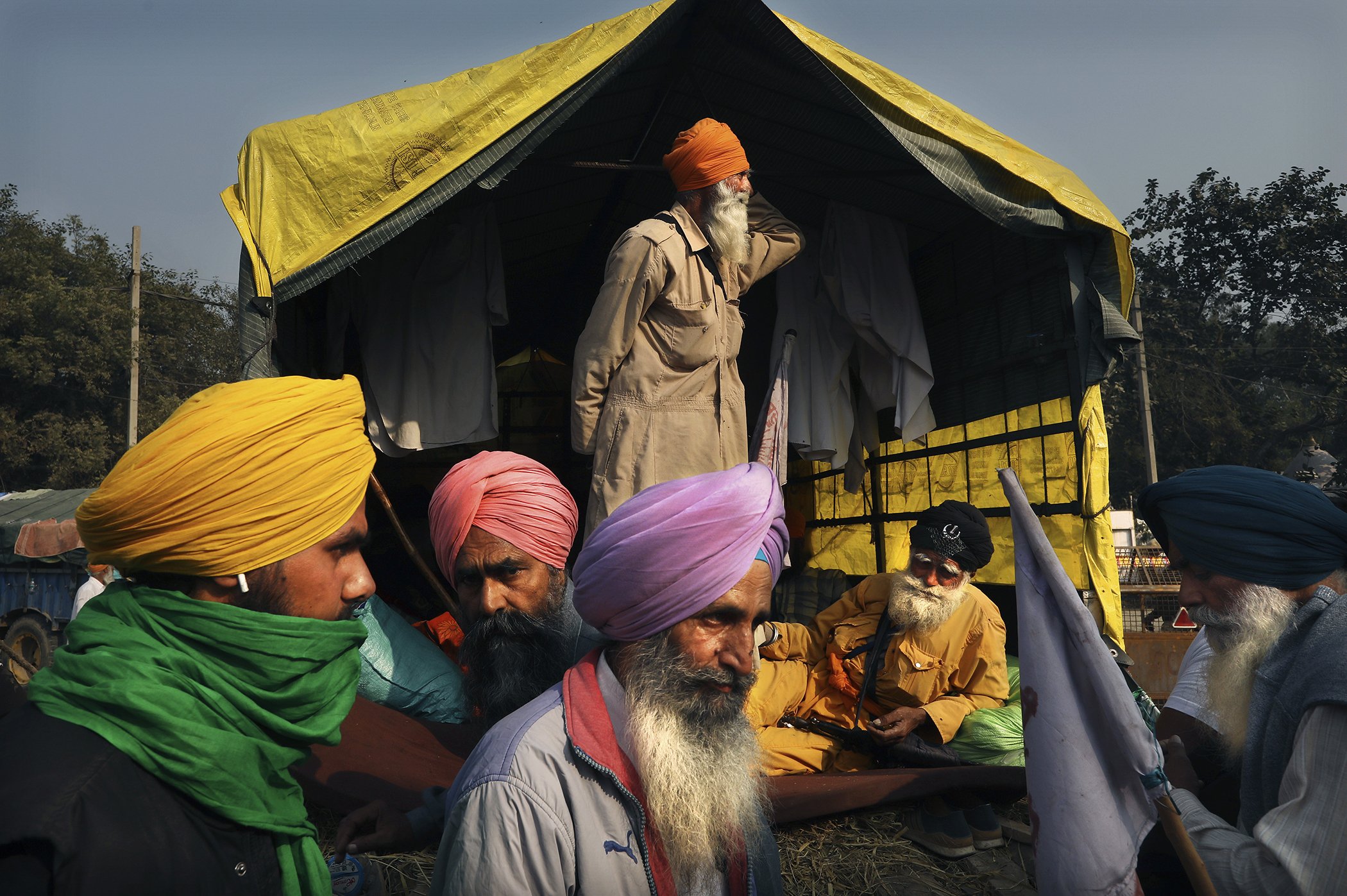 Indian farmers wait for the outcome of a meeting with the government at the protest site on a highway at the Delhi-Haryana state border, India, Dec.3, 2020.