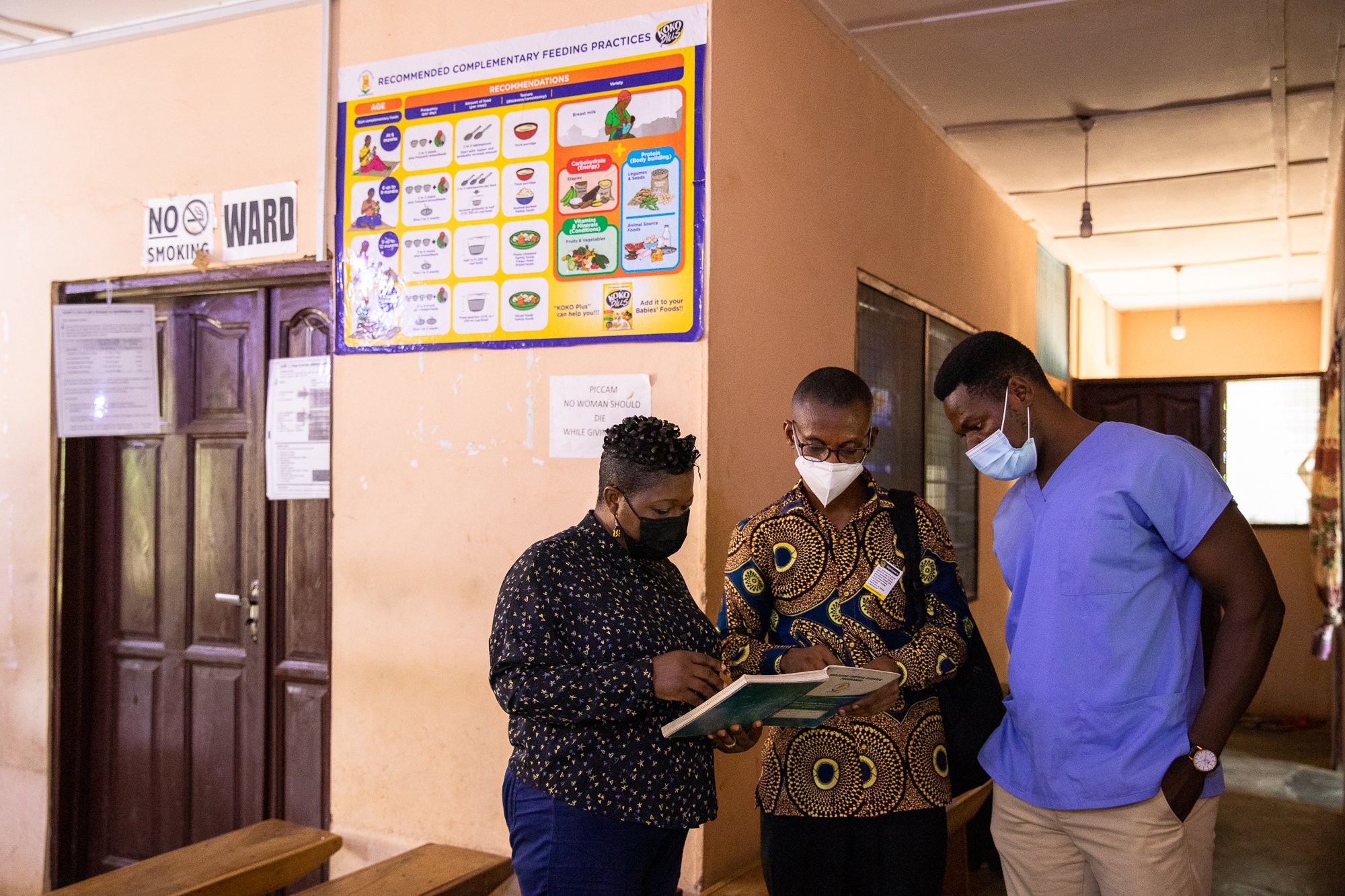 Dr Agatha Aboe (left) and David Agyemang, Program Manager, Sightsavers (middle) and Emmanuel Asiedu (right) look through patients records book at the Tinkong Clinic during a monitoring program at Akropong, Eastern, Ghana on June 28, 2021.