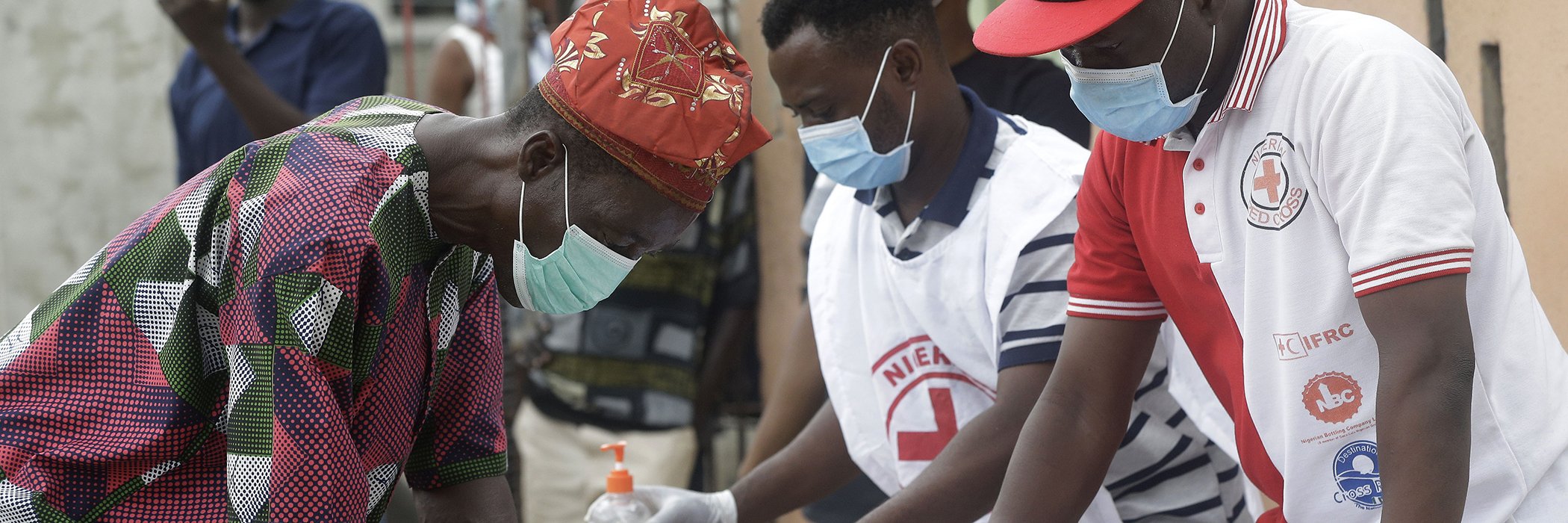 A resident of Makoko signs a register prior to being given food, by the Nigerian Red Cross, distributing food for those suffering under coronavirus related movement restrictions, in Lagos, Nigeria, April 25, 2020.