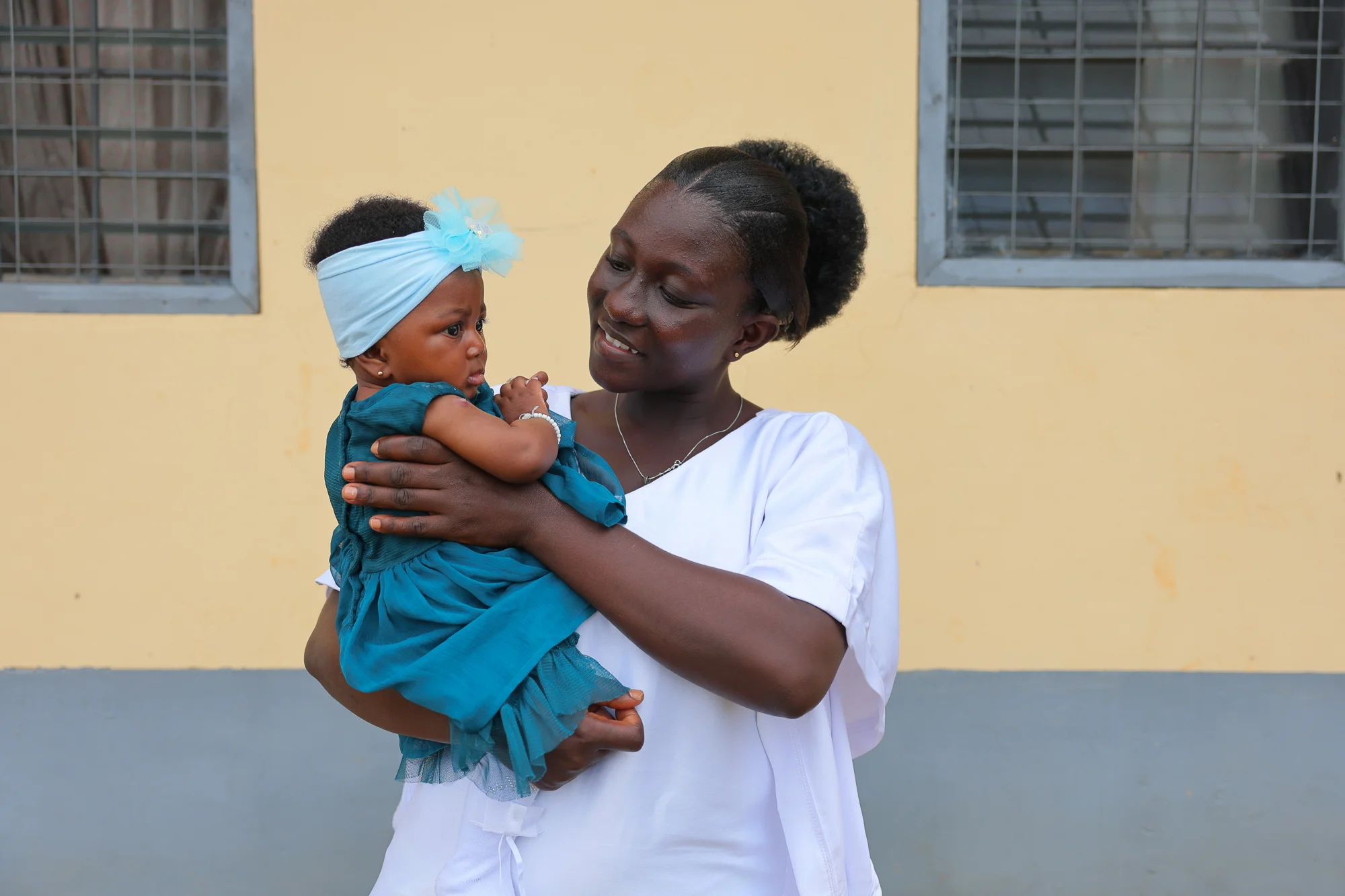 Abigail Debrah, 24, with her daughter at the Kotokuom CHPS Compound in the Ayemansa District, Eastern Region, Ghana, on July 16, 2025.