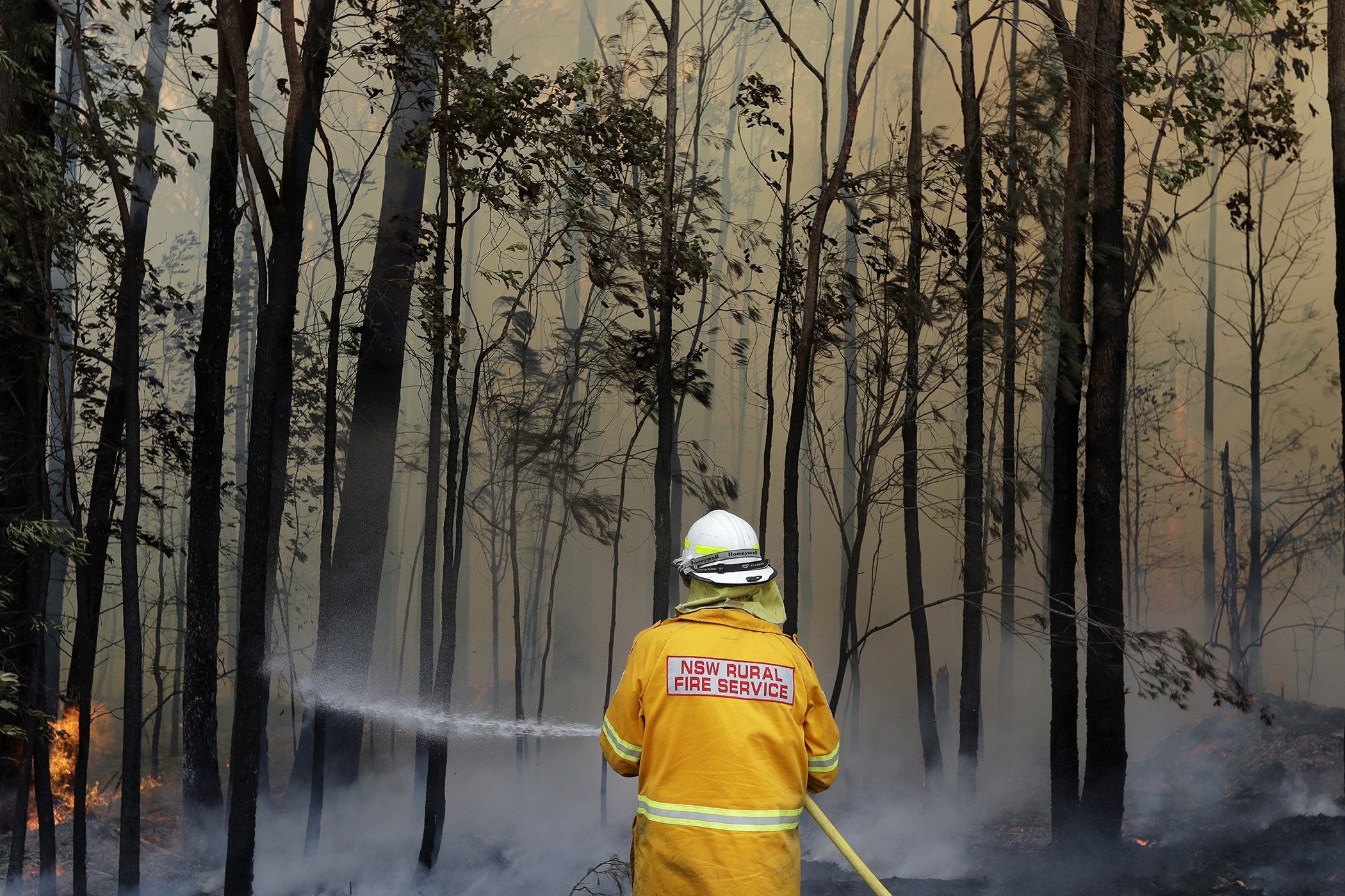 A firefighter manages a controlled burn near Tomerong, Australia, Jan. 8, 2020, in an effort to contain a larger fire nearby.