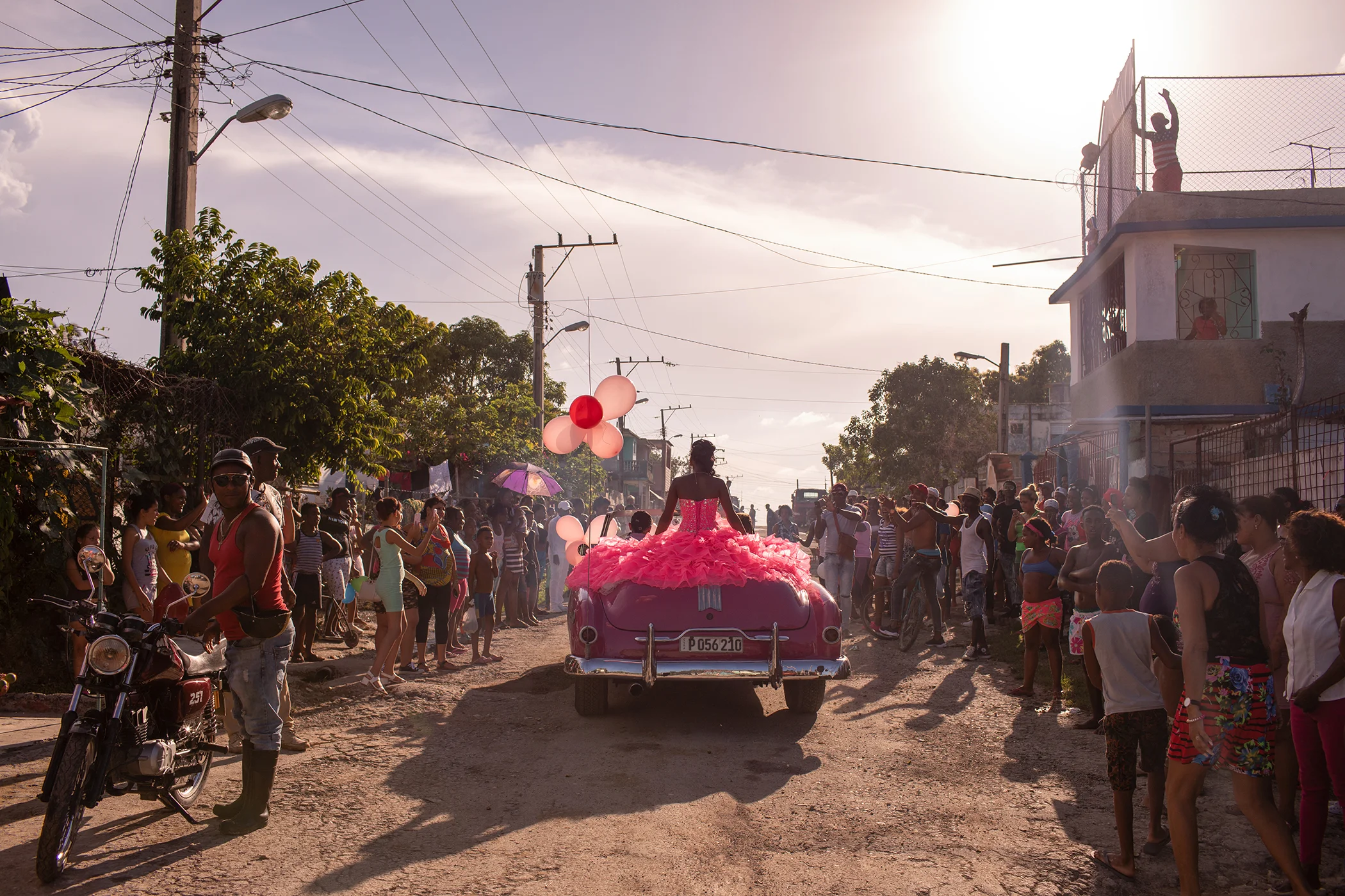 The Cubanitas: Pura rides around her neighborhood in a pink 1950s convertible, as the community gathers to celebrate her fifteenth birthday, in Havana, Cuba. Nominated in the Contemporary Issues Singles category.