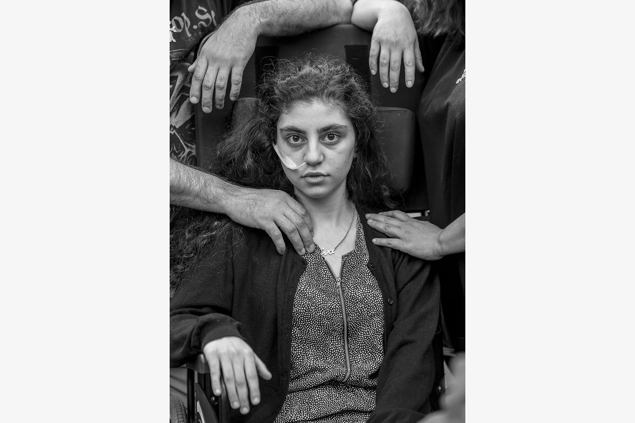 Ewa, 15-year-old Armenian girl who has recently woken from catatonic state brought on by Resignation Syndrome (RS), sits in a wheelchair next to her parents, in a refugee reception center in Poland. RS affects psychologically traumatized children.
