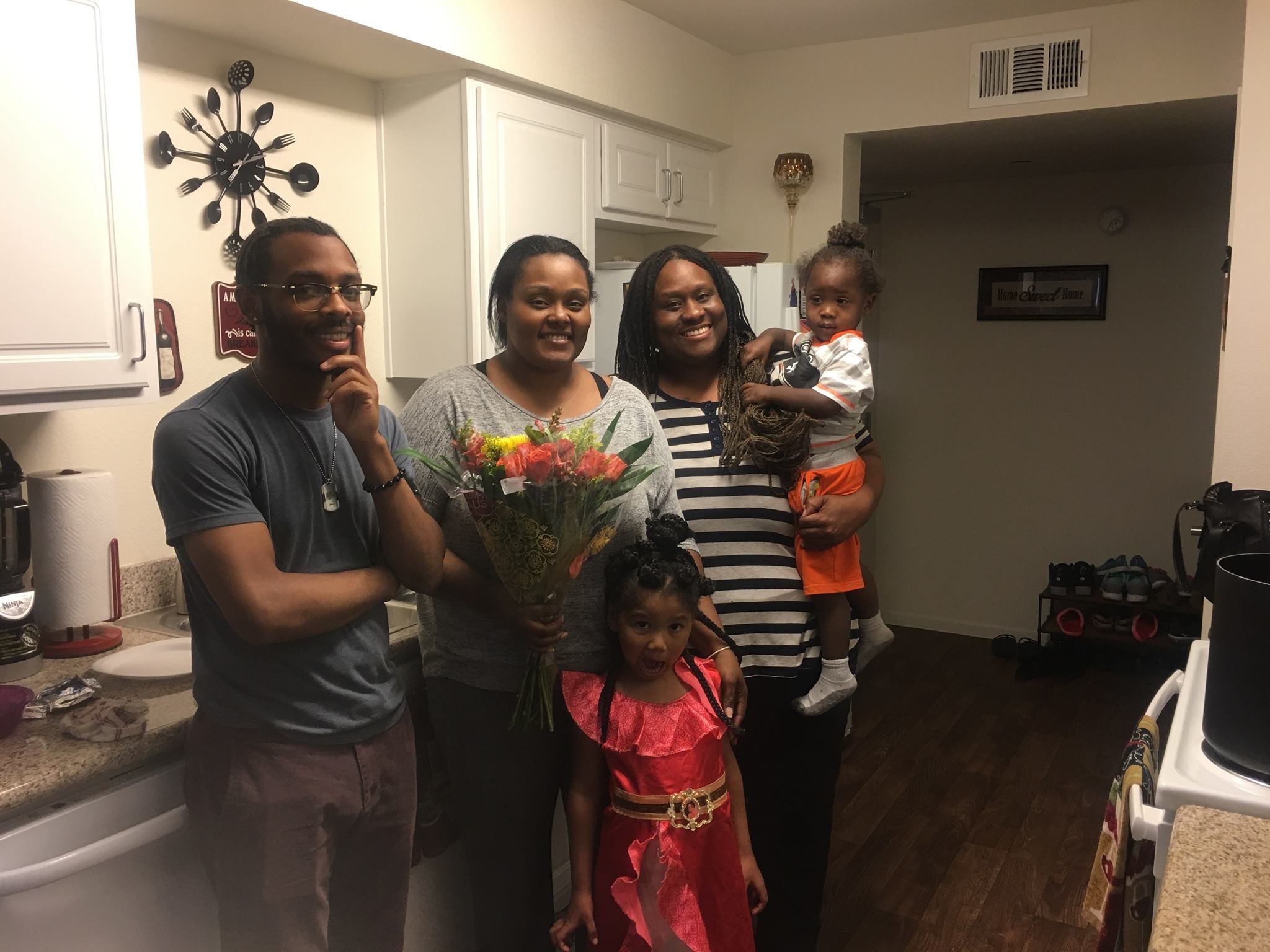 Tiara (center left) with Leslie Turner and her family at home after being bailed out.