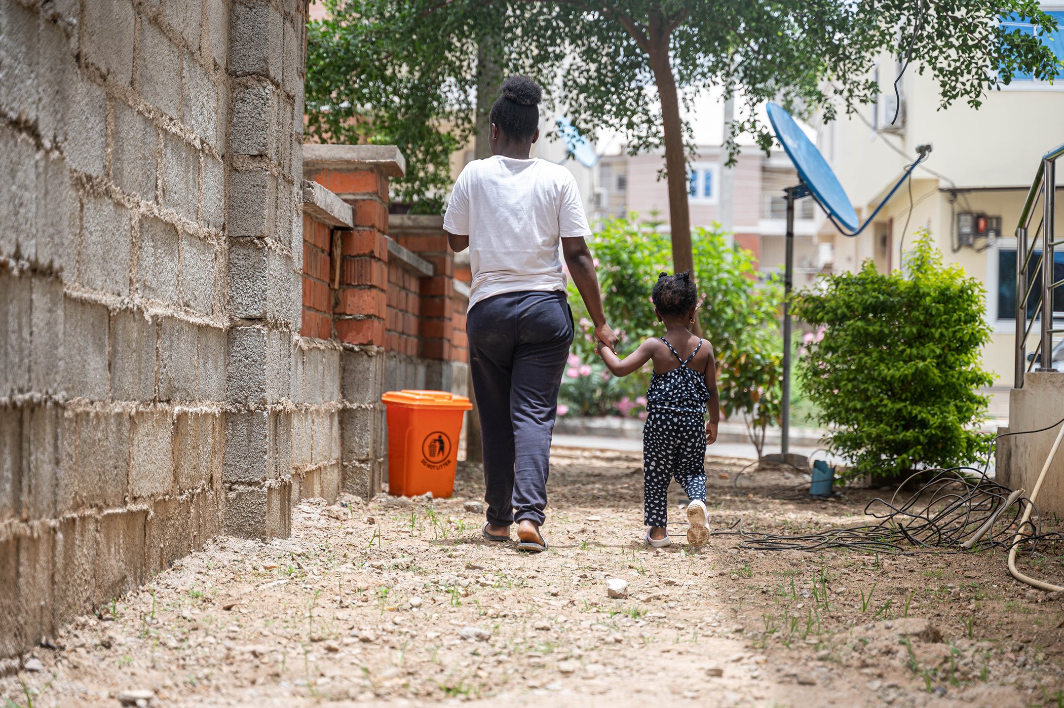 Sarah Solomon walks with the child she cares for at work. “I enjoy my work here as I’m able to rest more and save towards achieving my goal of becoming a psychologist,” said Solomon.