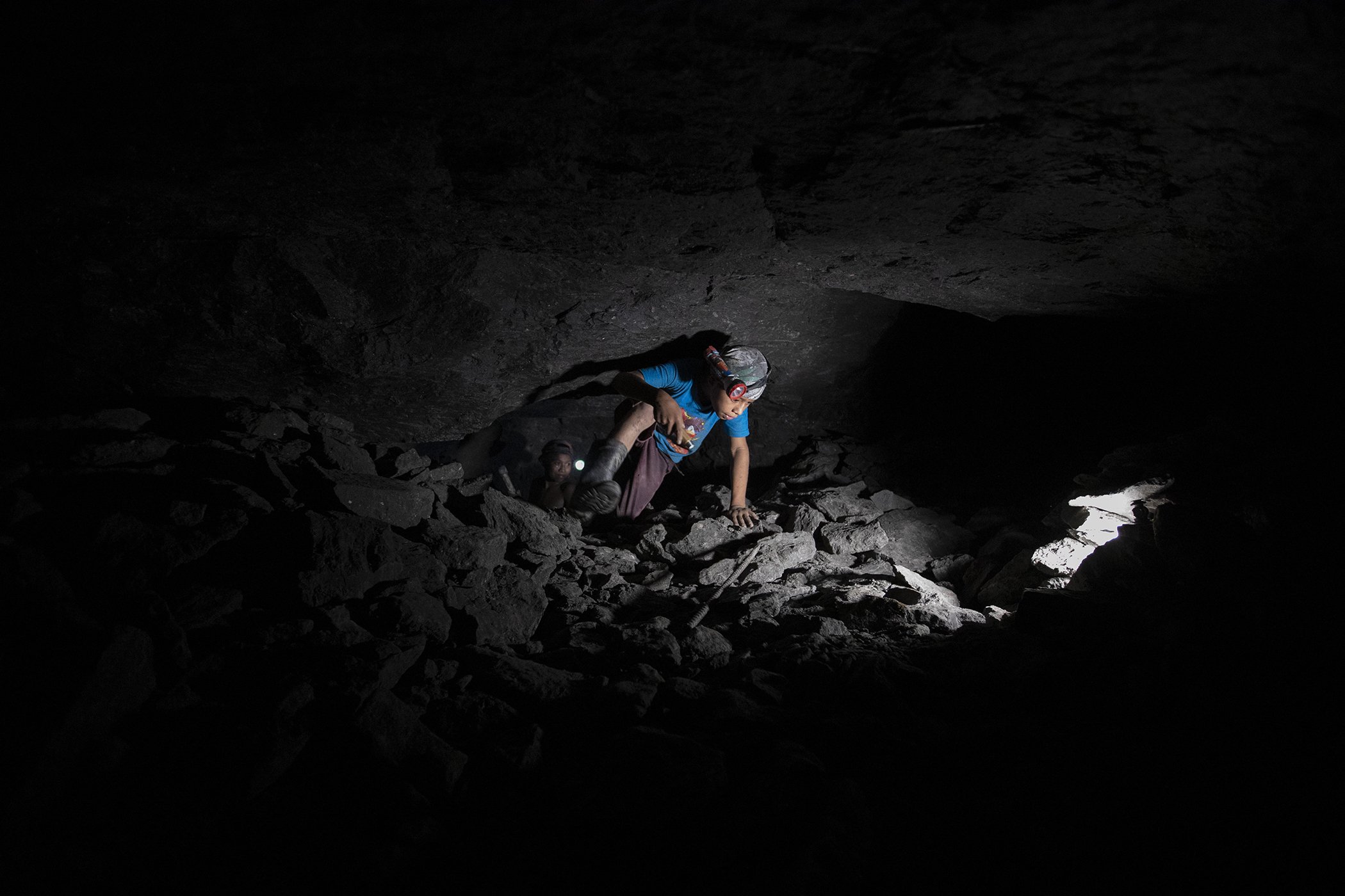 Andres Gomez, 11, works inside an amber mine in Chiapas state, Mexico, Sept. 10, 2020. Before the COVID-19 pandemic, he attended school and would spend a couple of hours mining after class, but since the school closed he is spending entire days mining.