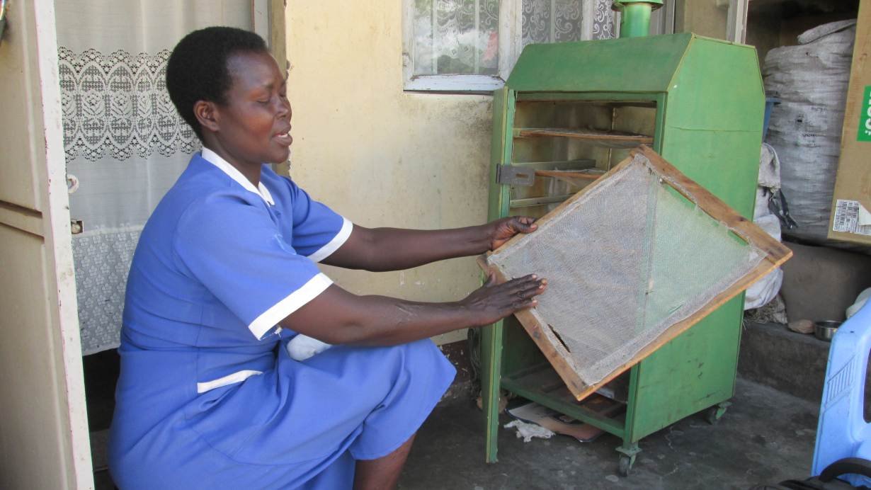 Nurse and farmer Christine Anek explains how she uses her eco-friendly food dryer in Pader district, northern Uganda, May 21, 2019.