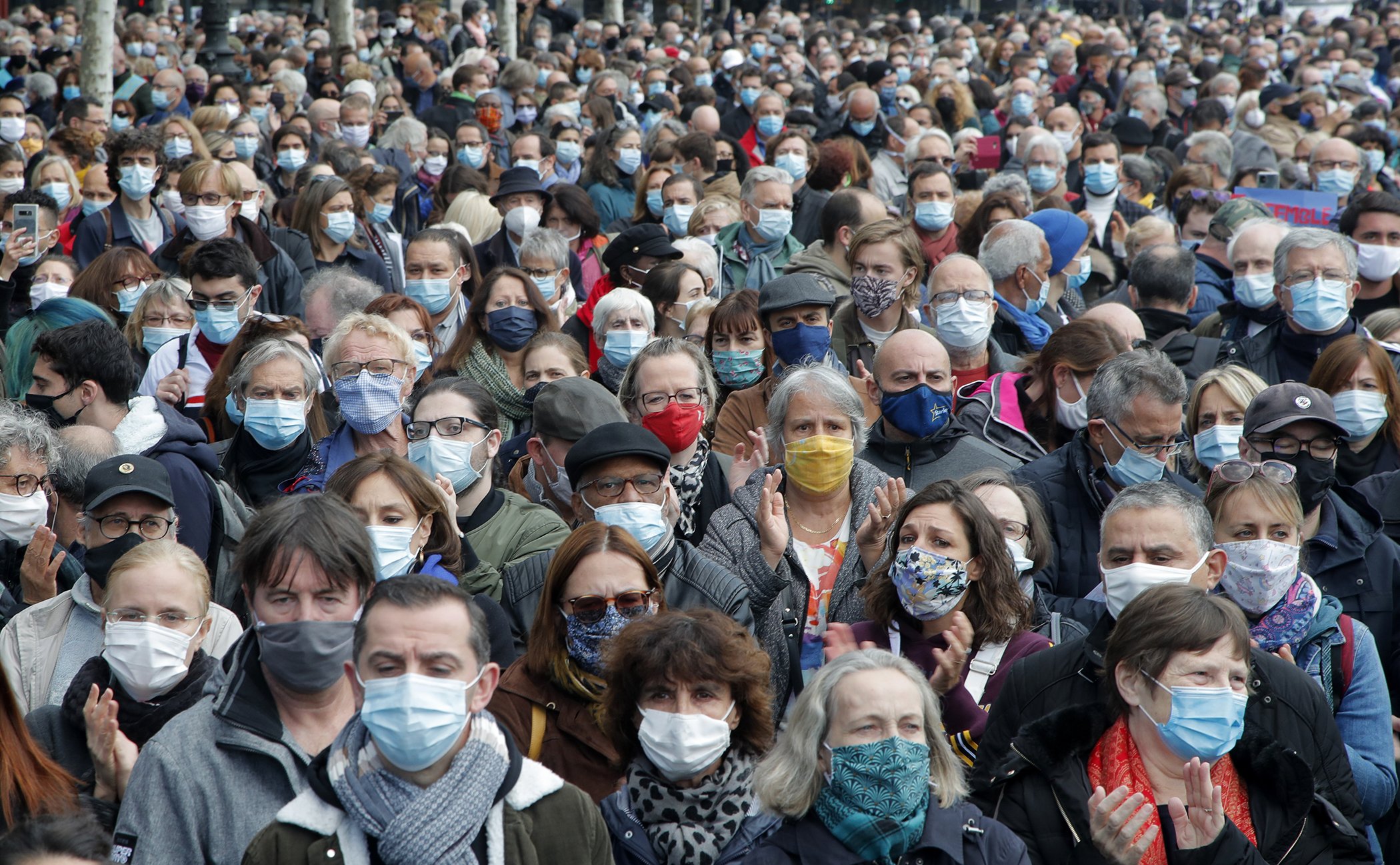 People gather on Republique in demonstration on Oct. 18, 2020 in Paris. Demonstrations around France have been called in support of freedom of speech and to pay tribute to French history teacher Samuel Paty.