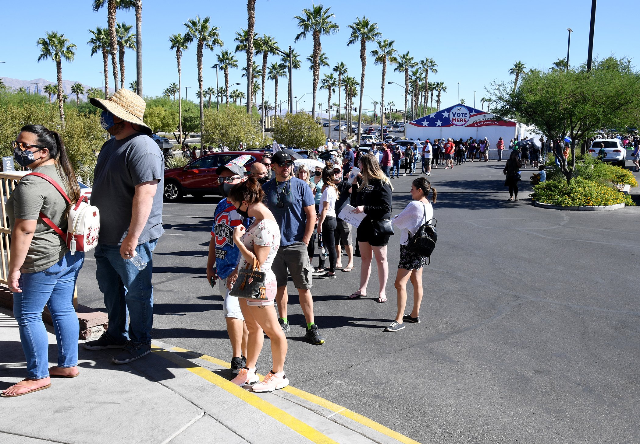 People line up to vote at a shopping center on the first day of in-person early voting on October 17, 2020 in Las Vegas, Nevada.