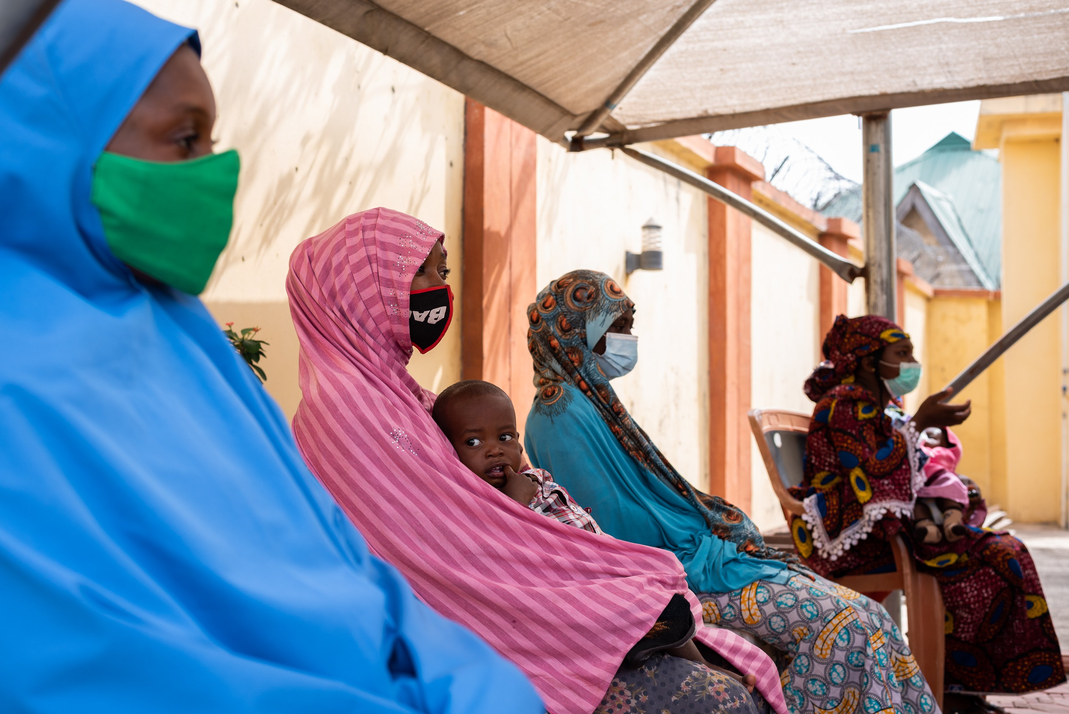Patients listen as a staff nurse explains the screening process before they register to be screened for breast and cervical cancer at the RAiSE Foundation center in Niger State on Feb. 23, 2021.
