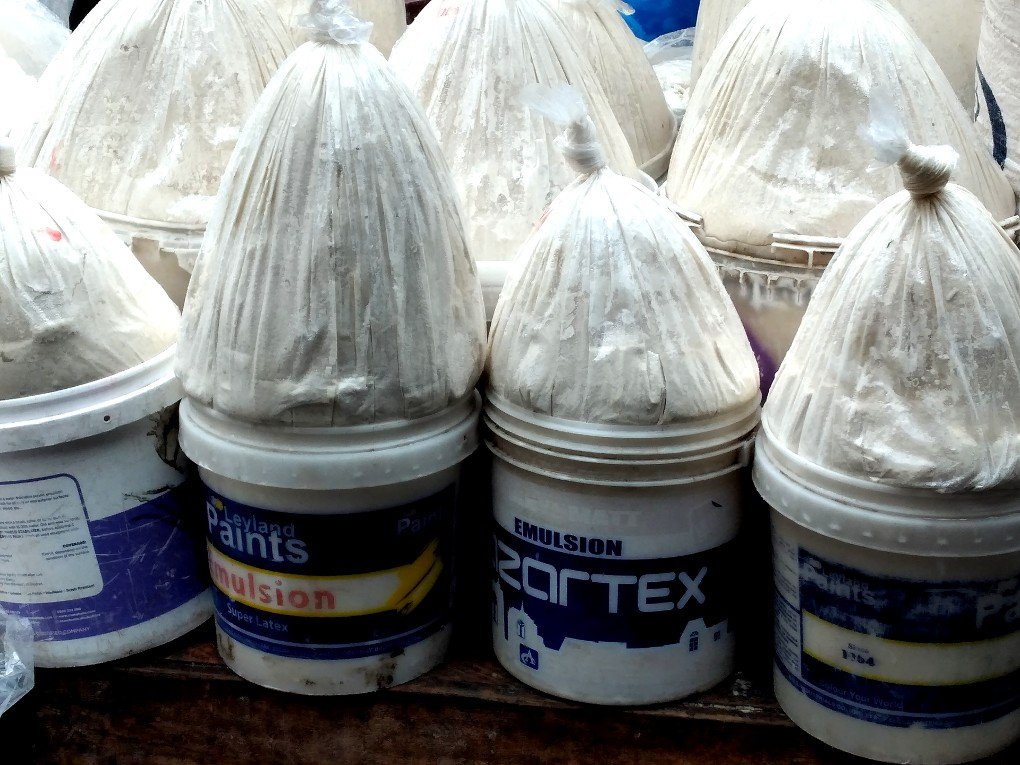 Buckets of corn dough on display at Madina market, Accra