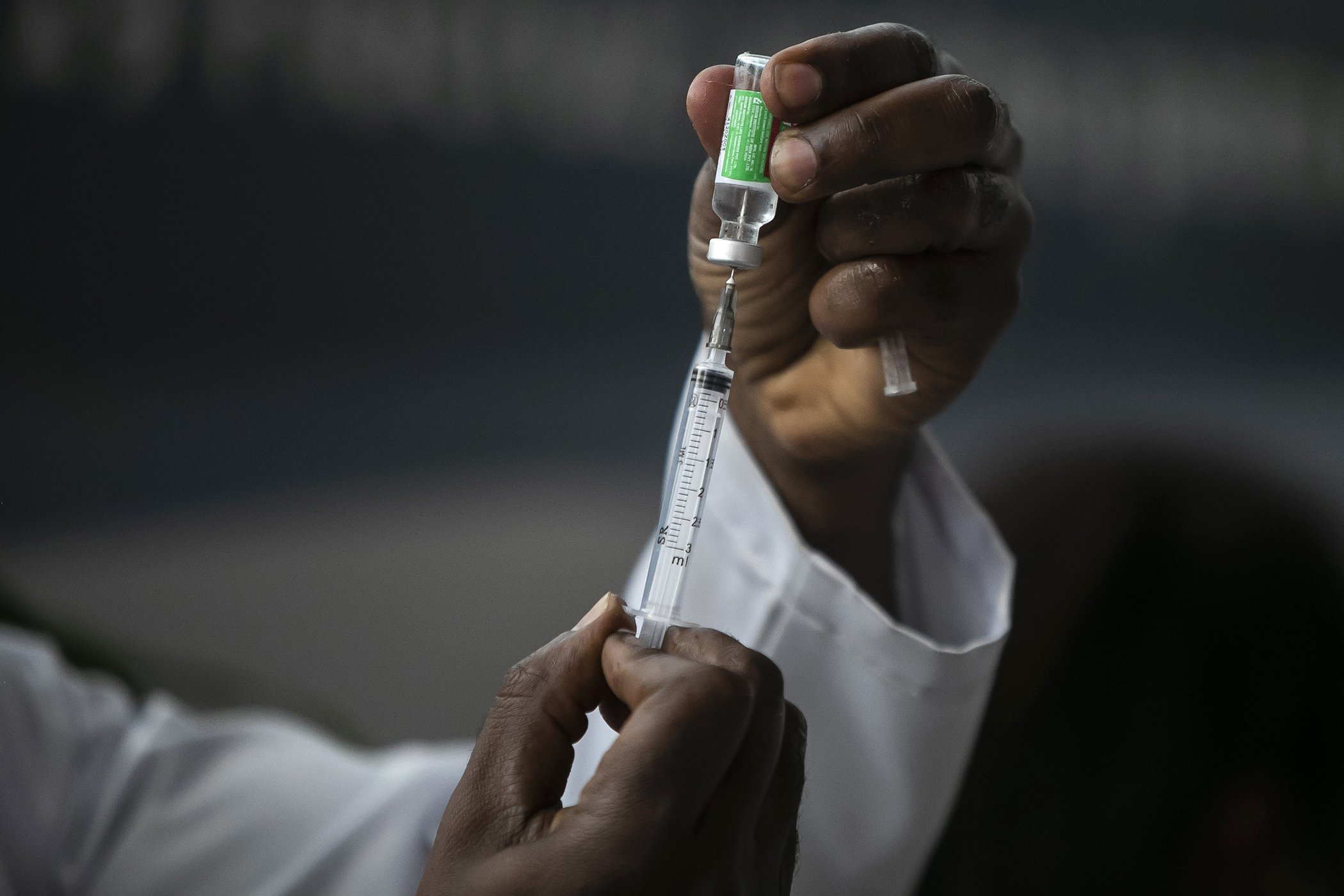 A healthcare worker prepares a dose of the Oxford-AstraZeneca vaccine for COVID-19 in Rio de Janeiro, Brazil, Jan. 23, 2021.