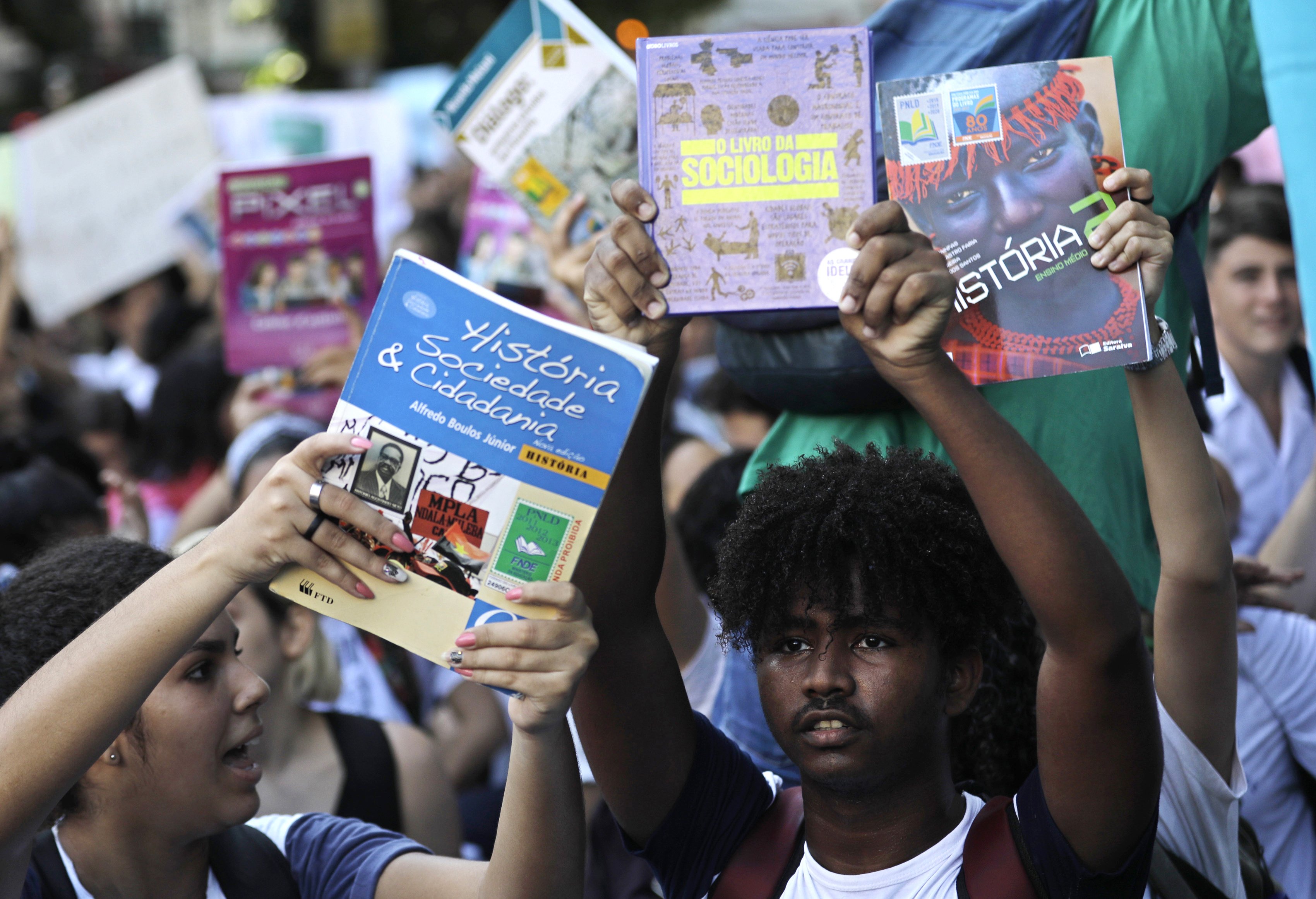 Public school students hold up history and sociology books during a protest against budget cuts in education outside the military school where Brazil's President Jair Bolsonaro attends a ceremony in Rio de Janeiro, Brazil, May 6, 2019.