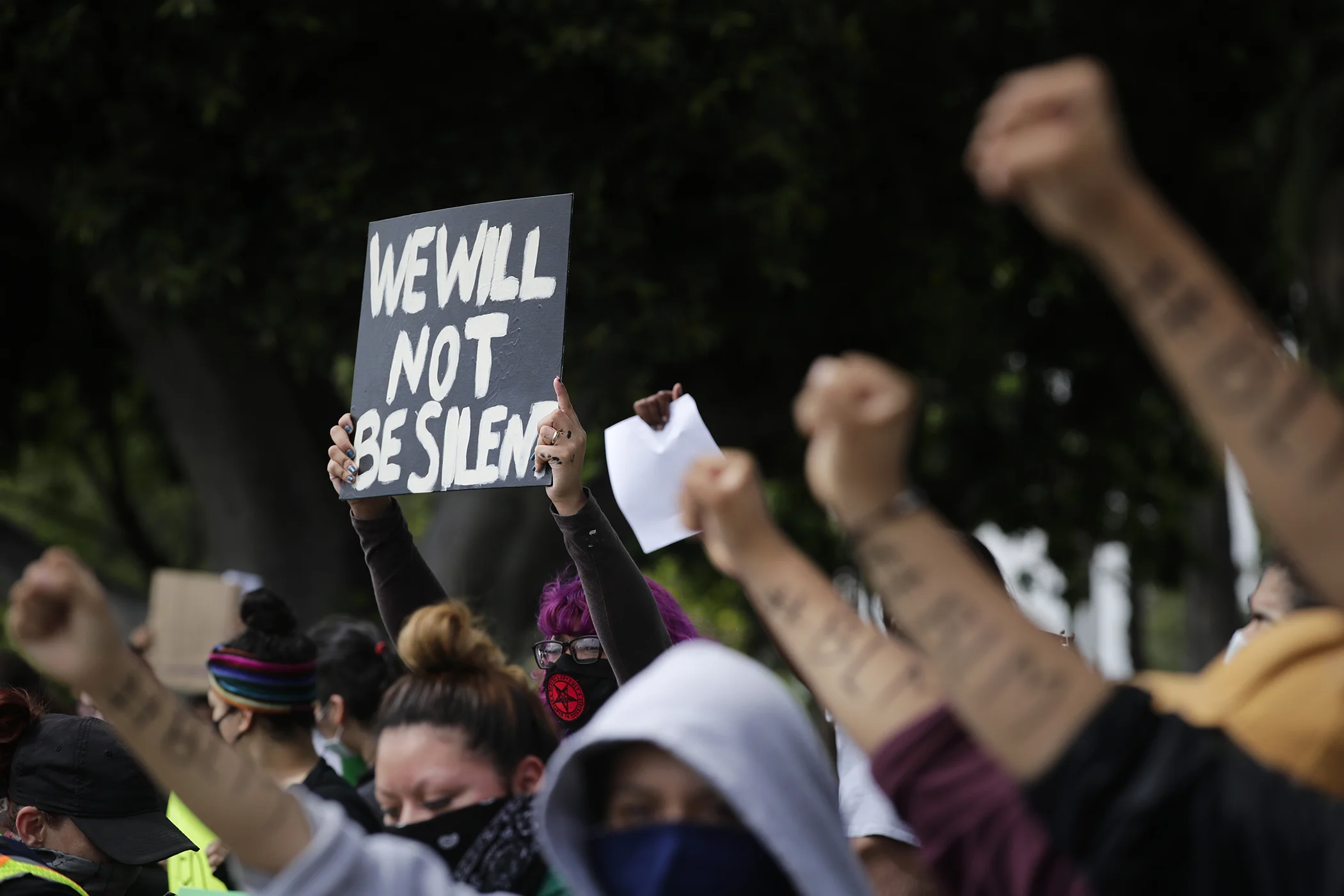 Demonstrators raise their fists during a protest, June 1, 2020, over the death of George Floyd, in Anaheim, Calif.