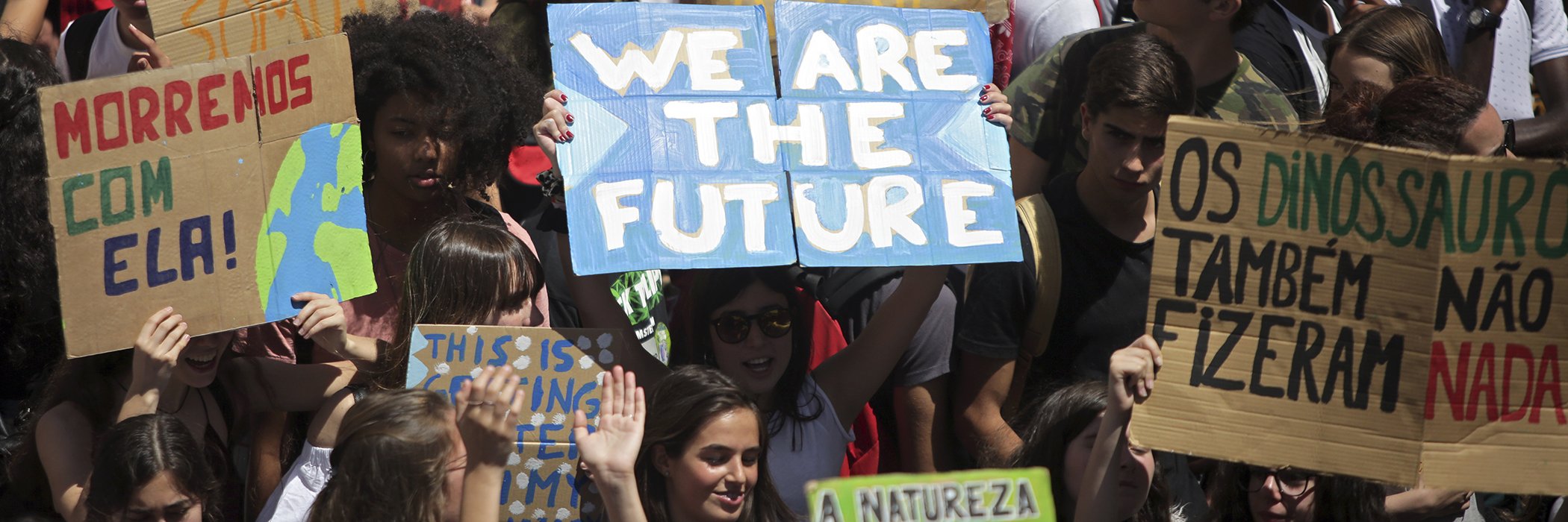 Demonstrators hold up posters outside the Portuguese parliament in Lisbon during a climate strike of school students as part of the Fridays for Future movements Friday, May 24, 2019.