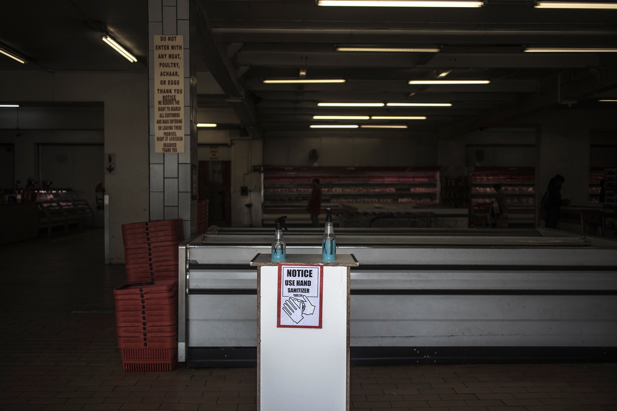 Hand sanitizing products are seen made available to customers at the entrance to a butcher at the Wanderers taxi rank in Johannesburg, on March 18, 2020.