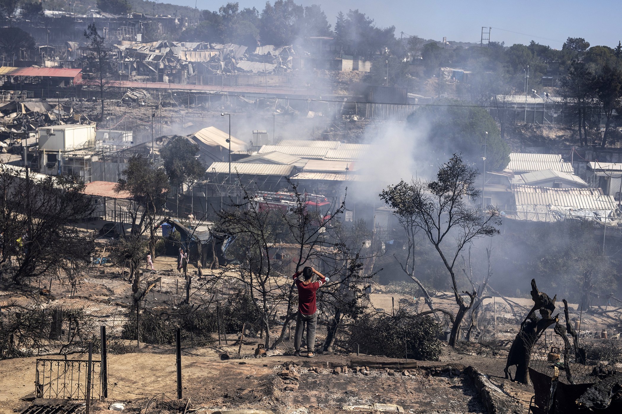 A migrant looks the burned Moria refugee camp on the northeastern Aegean island of Lesbos, Greece, on Sept. 9, 2020.