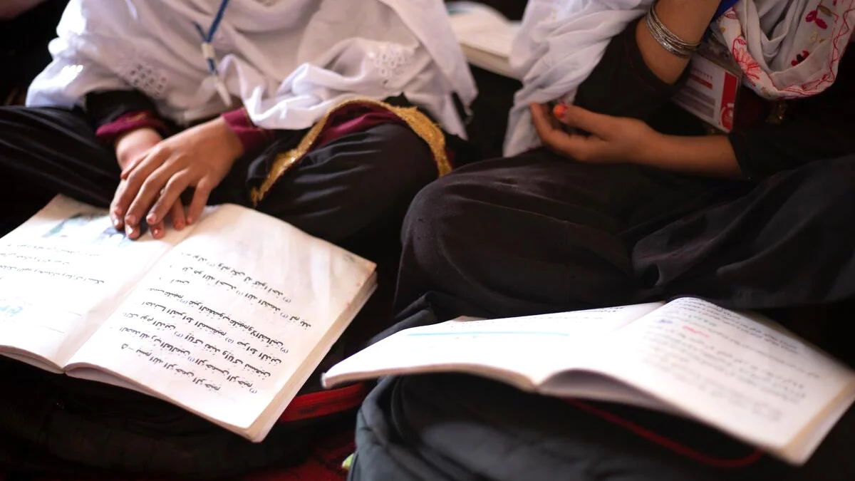 A student in Afghanistan holds her workbook. Education Cannot Wait and its partners are working to expand access to safe, inclusive learning for crisis-affected children.