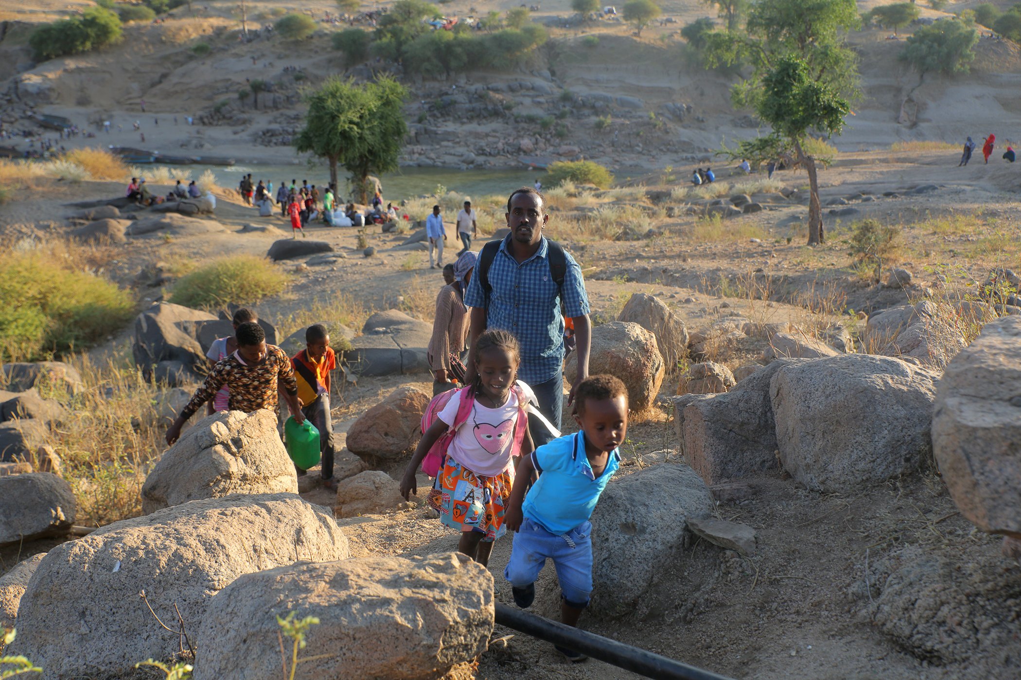 Ethiopian refugees cross the border into Hamdayet, Sudan. Since the violence began in early-November 2020, more than 14,500 children, women and men have fled into Sudan in search of safety, overwhelming the current capacity to provide aid.