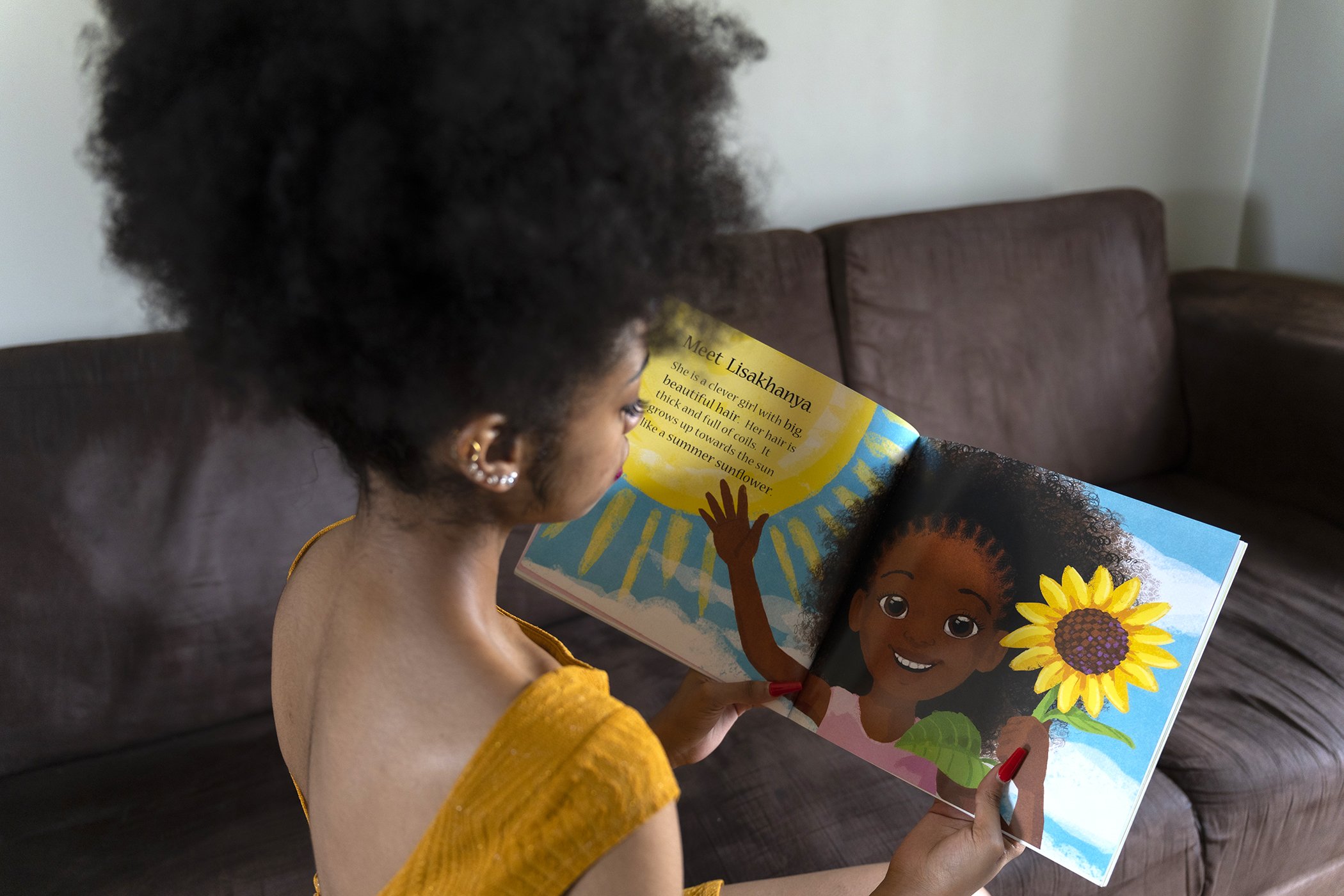 South African activist and author Zulaikha Patel with a copy of her children’s book “My Coily Crowny Hair” at her home in Midrand, South Africa in January 2023.