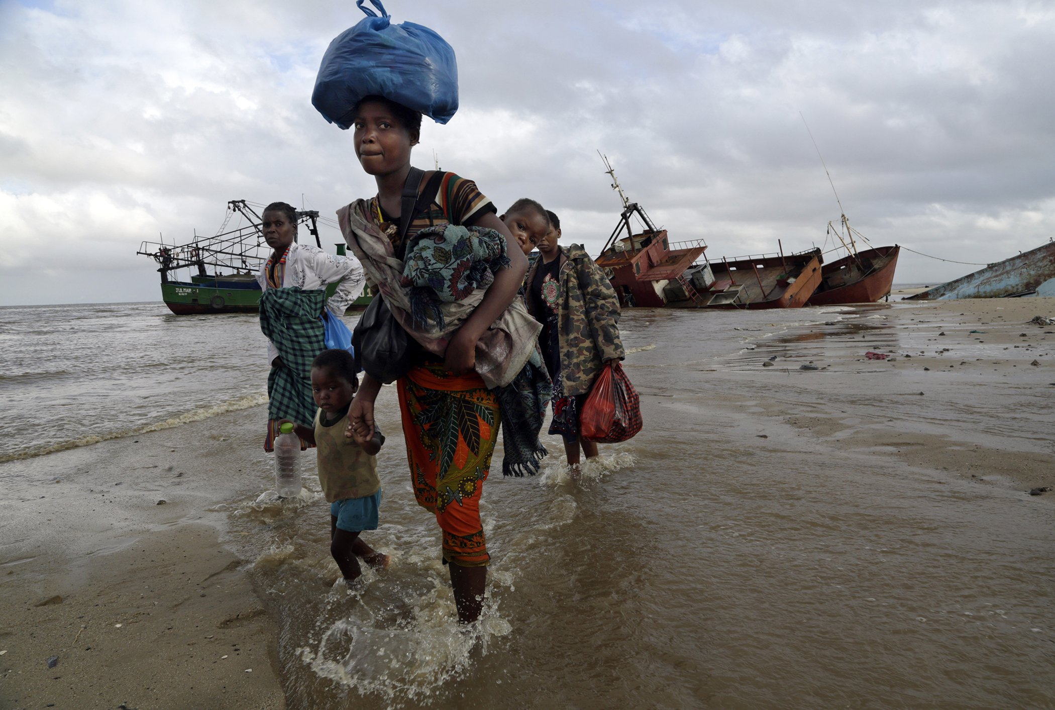 A displaced family arrives after being rescued by a boat from a flooded area of Buzi district, 200 kilometers (120 miles) outside Beira, Mozambique, on March 23, 2019.